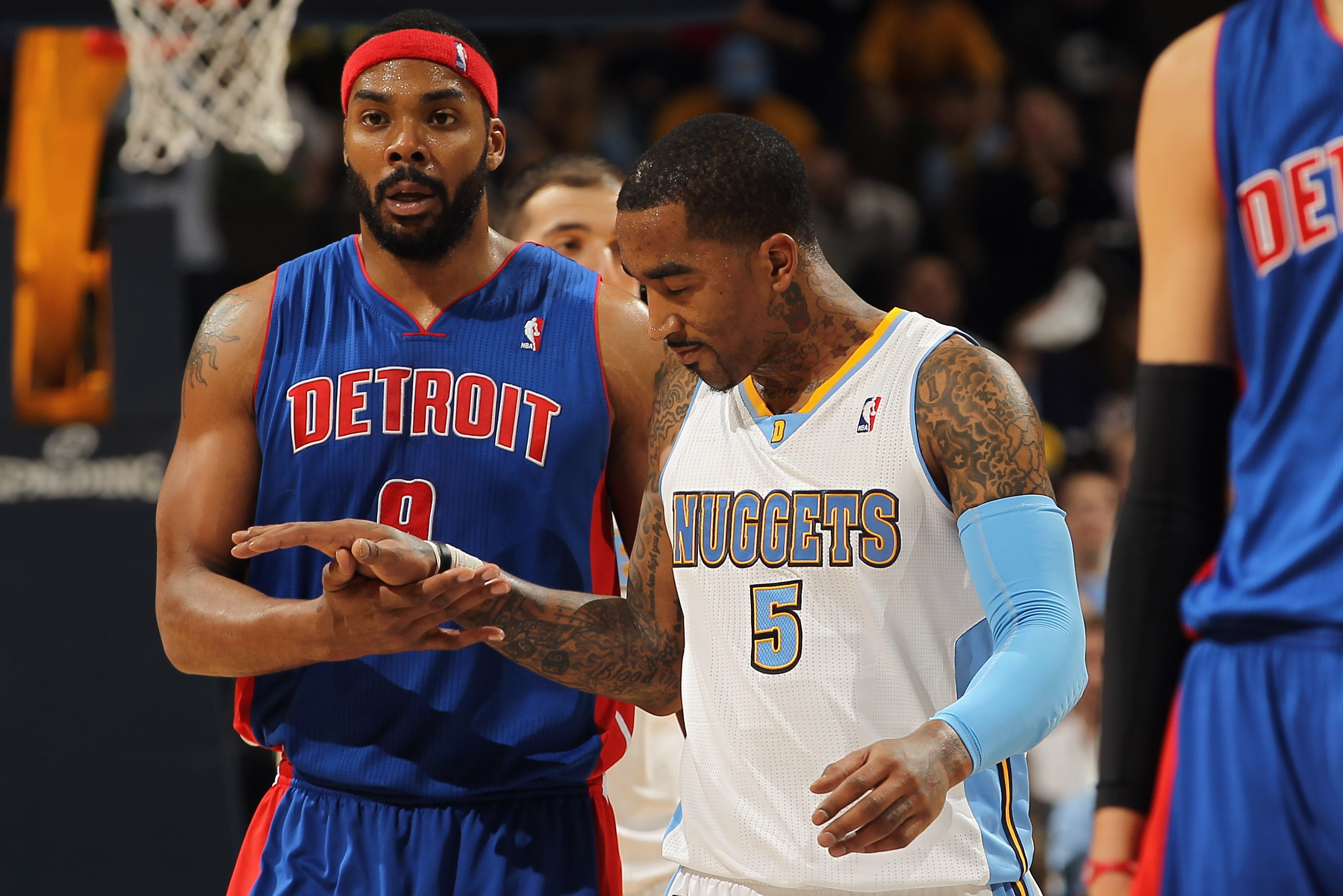 DENVER, CO - MARCH 12:  J.R. Smith #5 of the Denver Nuggets and Chris Wilcox #9 of the Detroit Pistons meet at midcourt after the game at the Pepsi Center on March 12, 2011 in Denver, Colorado. The Nuggets defeated the Pistons 131-101.  NOTE TO USER: User