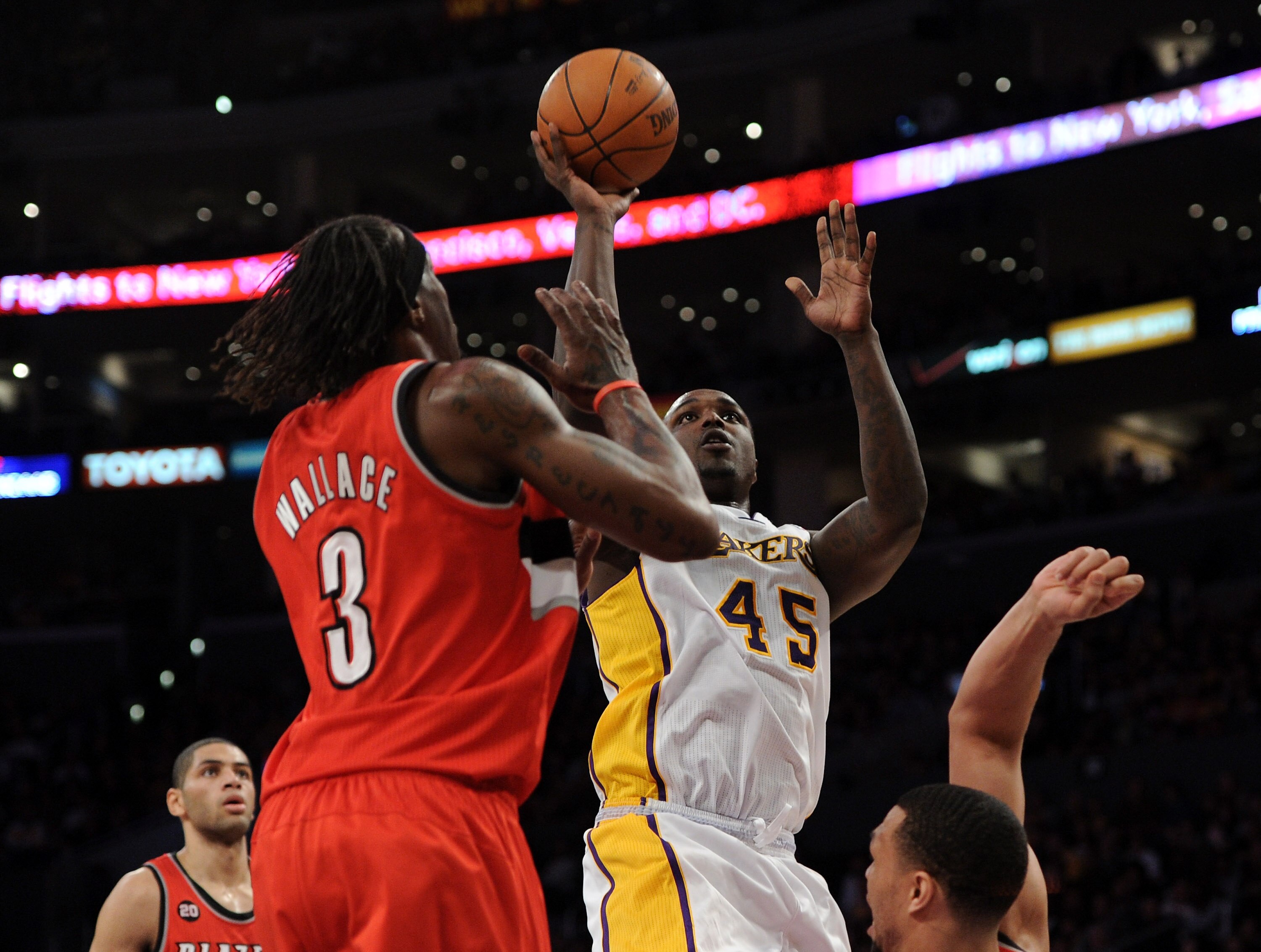 LOS ANGELES, CA - MARCH 20:  Derrick Caracter #45 of the Los Angeles Lakers attempts a layup in front of Gerlad Wallace #3 of the Portland Trail Blazers at the Staples Center on March 20, 2011 in Los Angeles, California.  NOTE TO USER: User expressly ackn