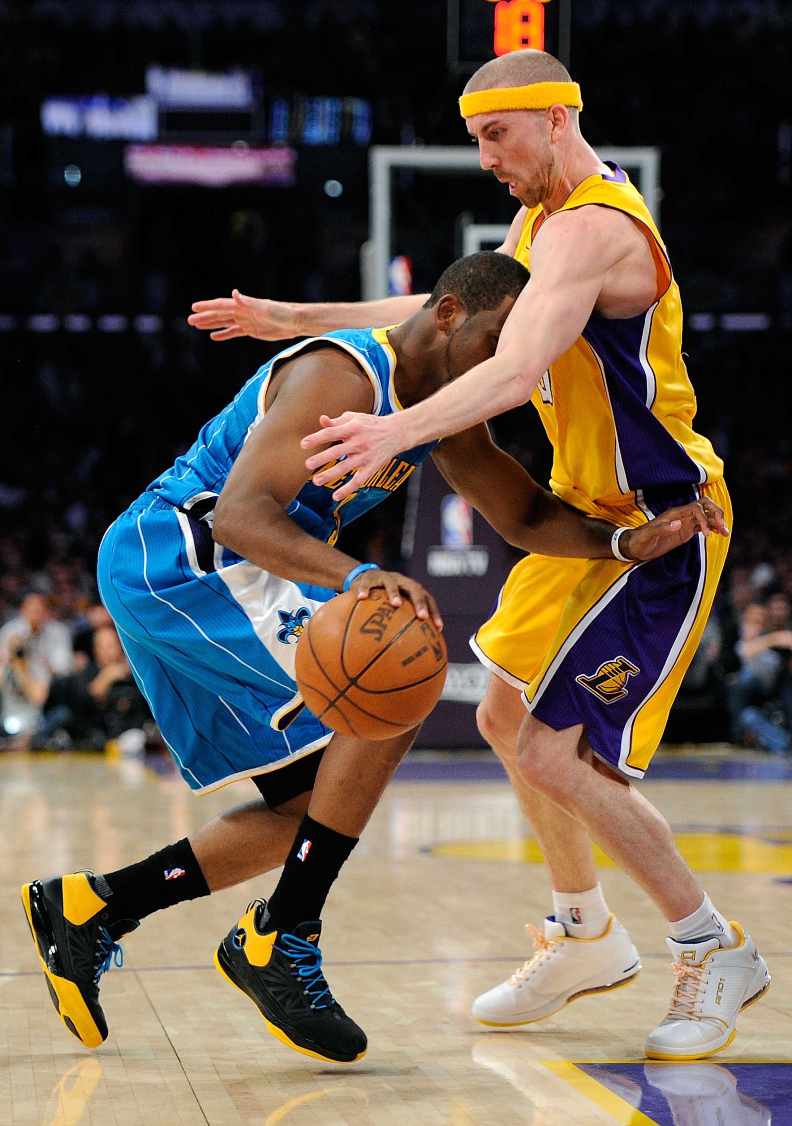 LOS ANGELES, CA - APRIL 20:  Chris Paul #3 of the New Orleans Hornets drives into Steve Blake #5 of the Los Angeles Lakers in Game Two of the Western Conference Quarterfinals in the 2011 NBA Playoffs on April 20, 2011 at Staples Center in Los Angeles, Cal