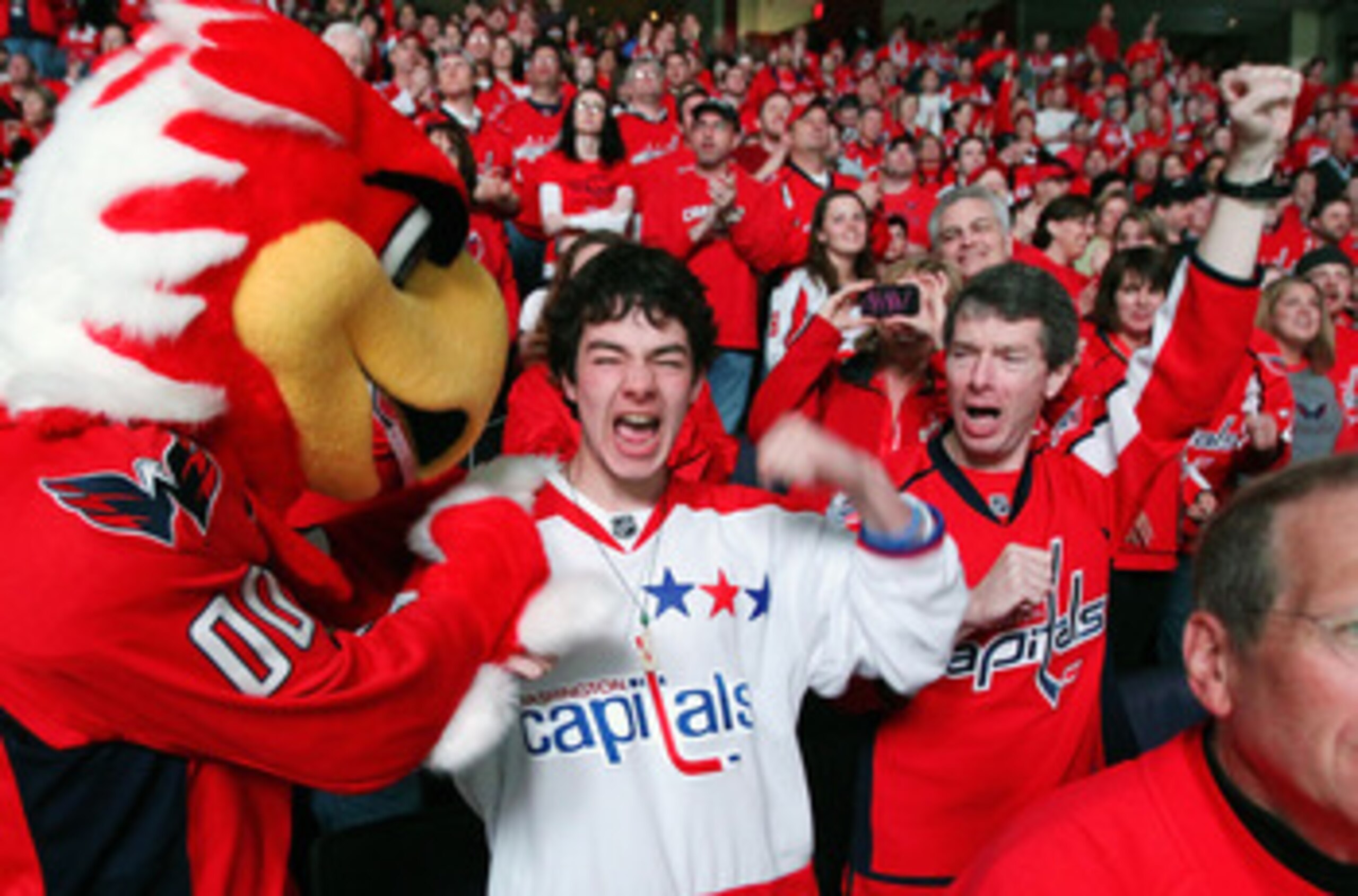 WASHINGTON , DC - APRIL 23: Fans of the Washington Capitals cheer their team on following a 3-1 win over the New York Rangers in Game Five of the Eastern Conference Quarterfinals during the 2011 NHL Stanley Cup Playoffs at the Verizon Center on April 23, WASHINGTON , DC - APRIL 23: Fans of the Washington Capitals cheer their team on following a 3-1 win over the New York Rangers in Game Five of the Eastern Conference Quarterfinals during the 2011 NHL Stanley Cup Playoffs at the Verizon Center on April 23,