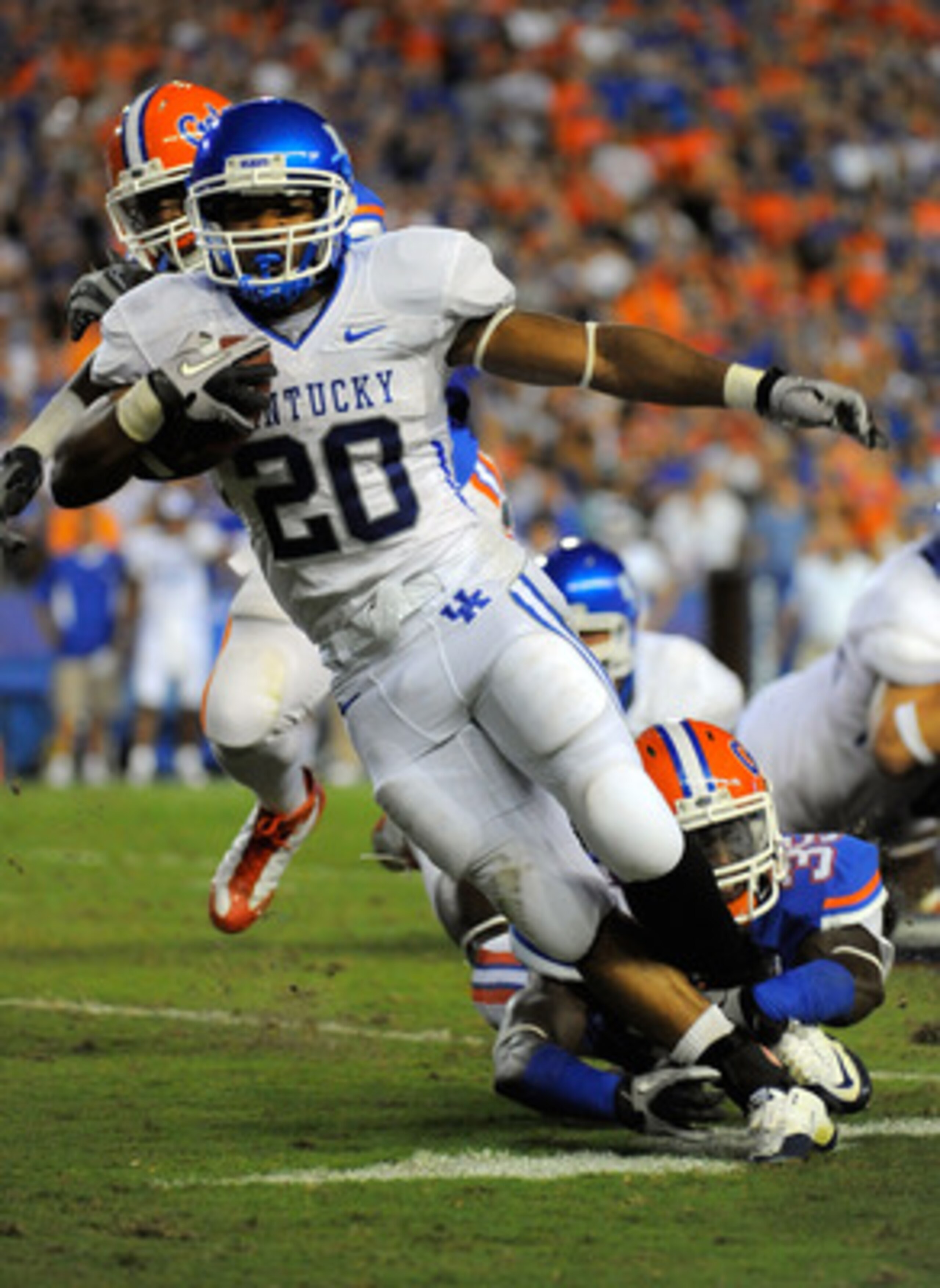 GAINESVILLE, FL - SEPTEMBER 25:  Running back Derrick Locke #20 of the Kentucky Wildcats is brought down by safety Ahmad Black #35 of the Florida Gators at Ben Hill Griffin Stadium on September 25, 2010 in Gainesville, Florida.  (Photo by Doug Benc/Getty 