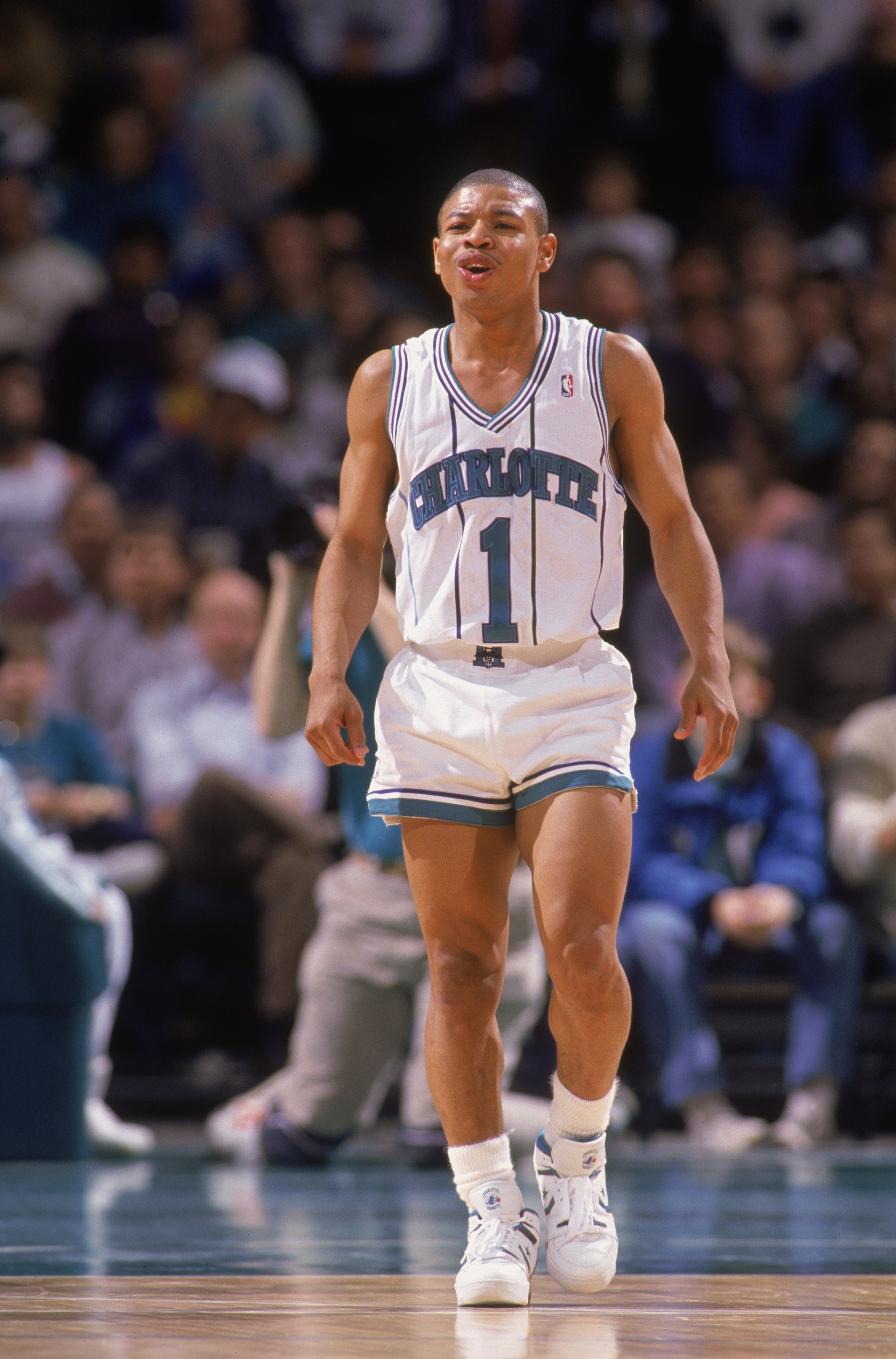 CHARLOTTE, NC - 1989:  Mugsy Bogues #1 of the Charlotte Hornets walks on the court during an NBA game at Charlotte Colesium in 1989. (Photo by Jim Gund/Getty Images)