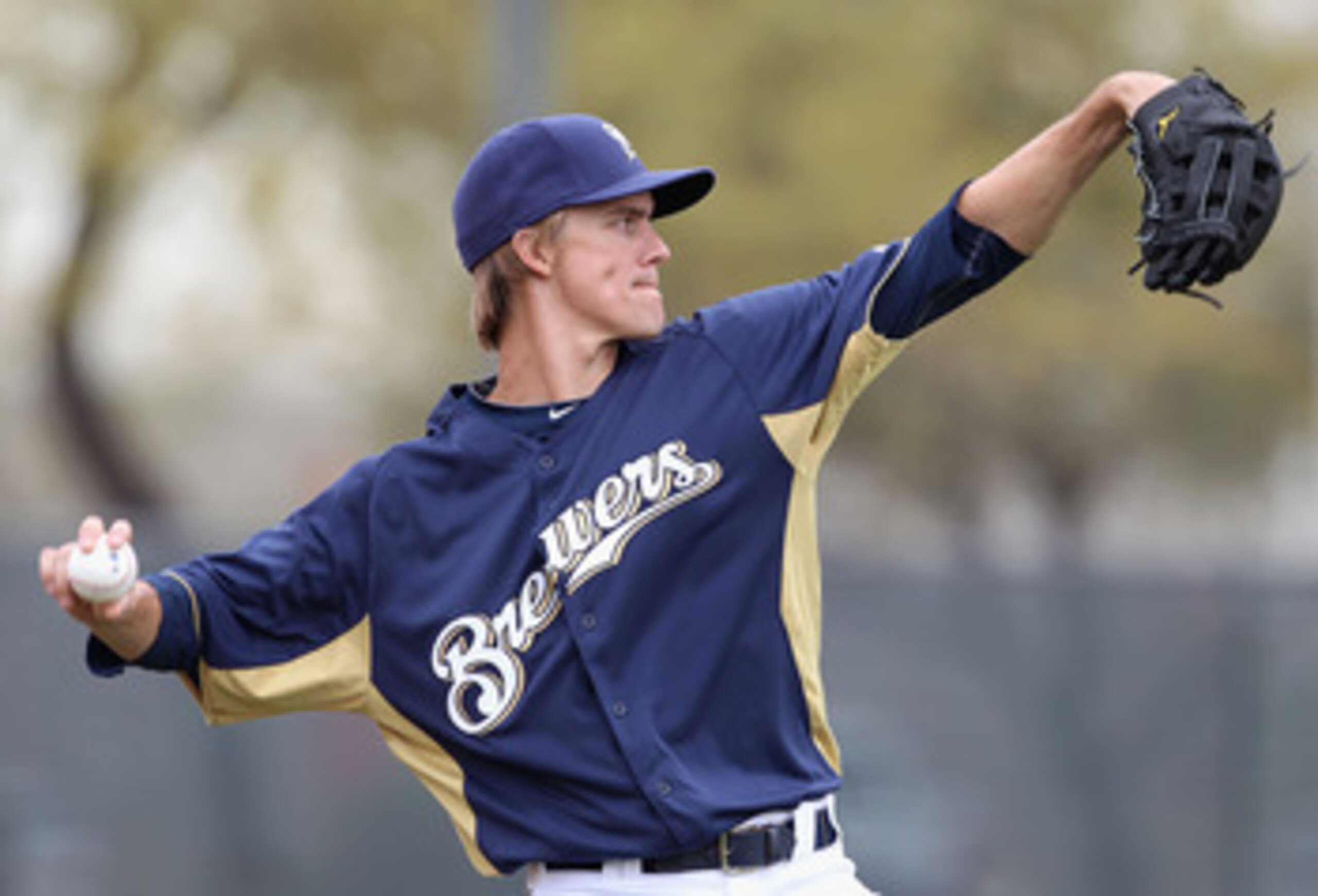 PHOENIX, AZ - FEBRUARY 18:  Pitcher Zack Greinke #13 of the Milwaukee Brewers warms up during a MLB spring training practice at Maryvale Baseball Park on February 18, 2011 in Phoenix, Arizona.  (Photo by Christian Petersen/Getty Images)