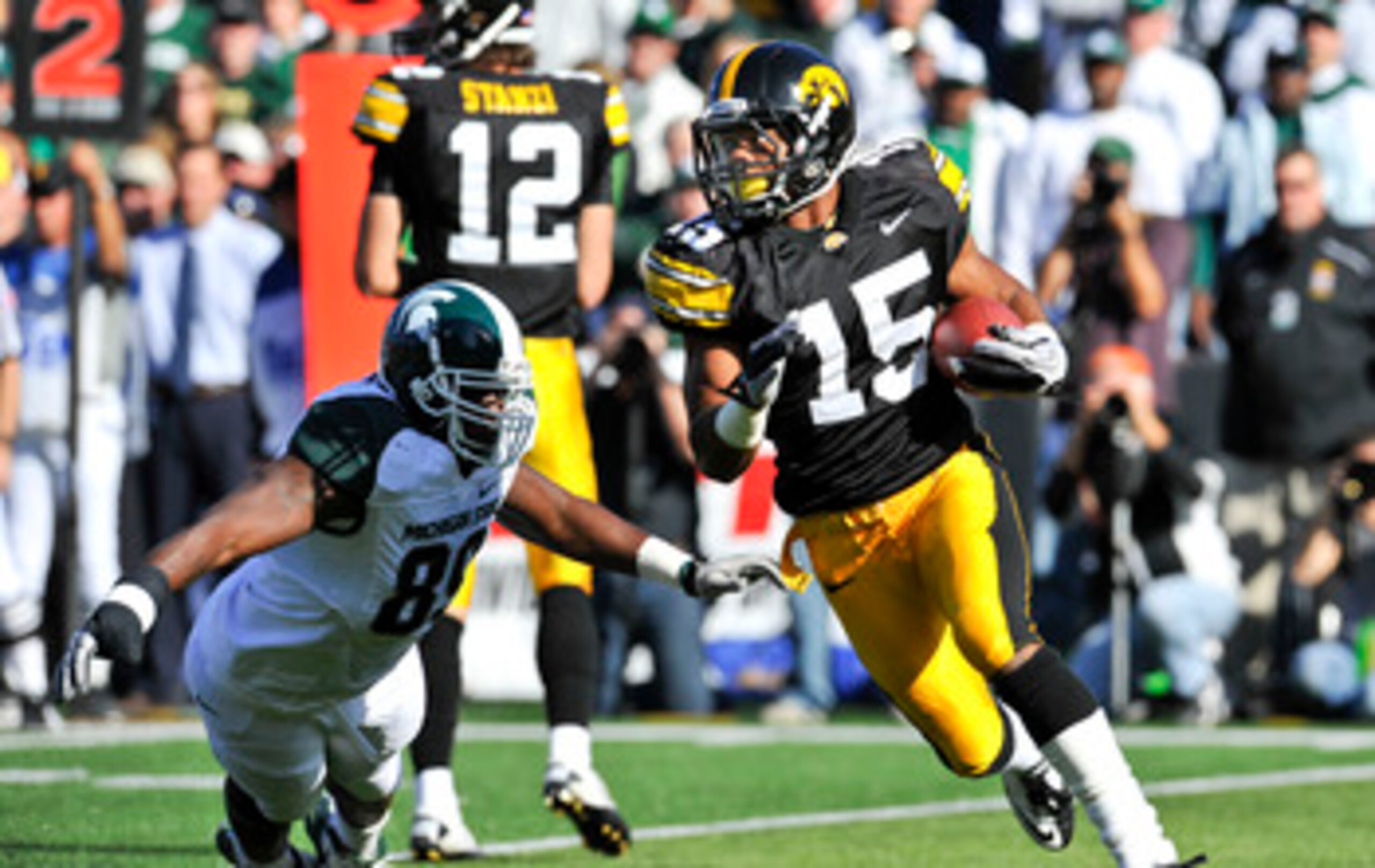 IOWA CITY, IA - OCTOBER 30: Wide reciver Derrell Johnson-Koulianos #15 of the University of Iowa Hawkeyes runs the ball past defensive end Colin Neely #89 of the Michigan State Spartans during the first half of play at Kinnick Stadium on October 30, 2010