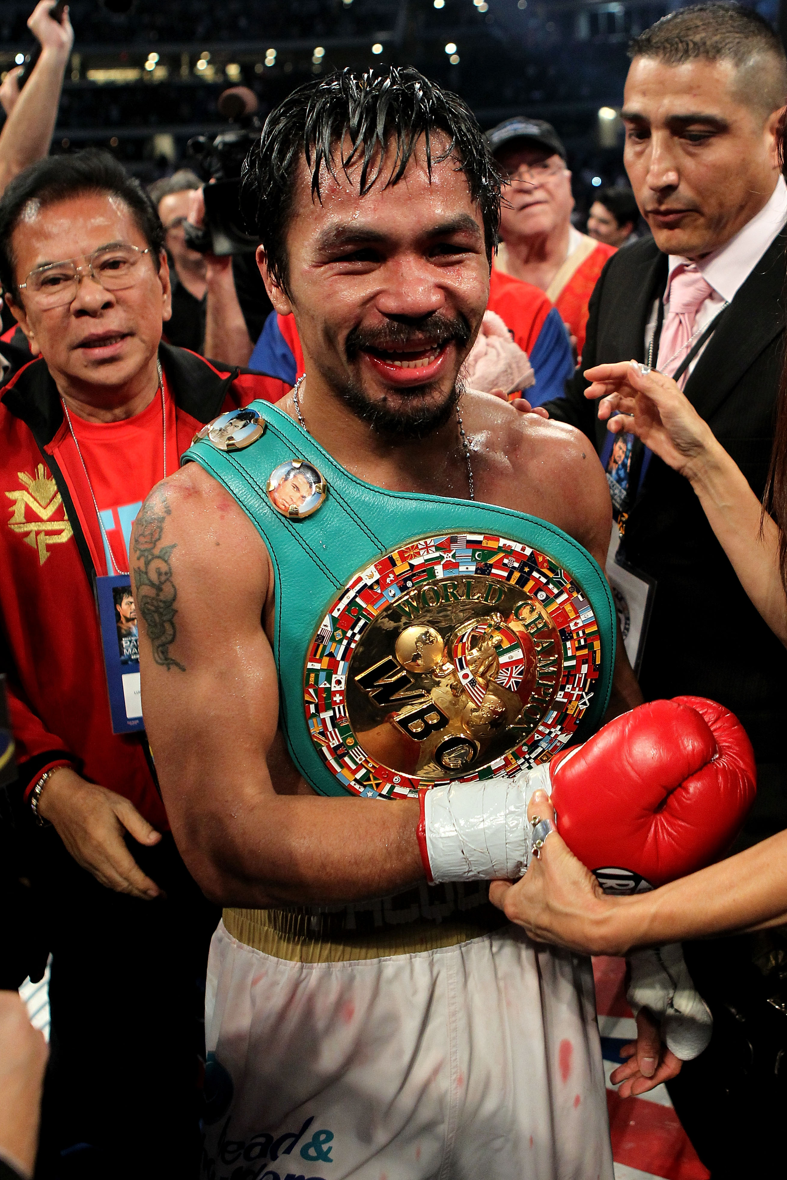 ARLINGTON, TX - NOVEMBER 13:  Manny Pacquiao (white trunks) of the Philippines celebrates after he was declared the winner by a unanimous decision against Antonio Margarito (black trunks) of Mexico during their WBC World Super Welterweight Title bout at C