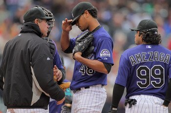 DENVER, CO - MAY 01:  Pitching coach Bob Apodaca (L) of the Colorado Rockies visits the mound to talk with pitcher Esmil Rogers #48 of the Colorado Rockies as he works against the Pittsburgh Pirates at Coors Field on May 1, 2011 in Denver, Colorado. The P