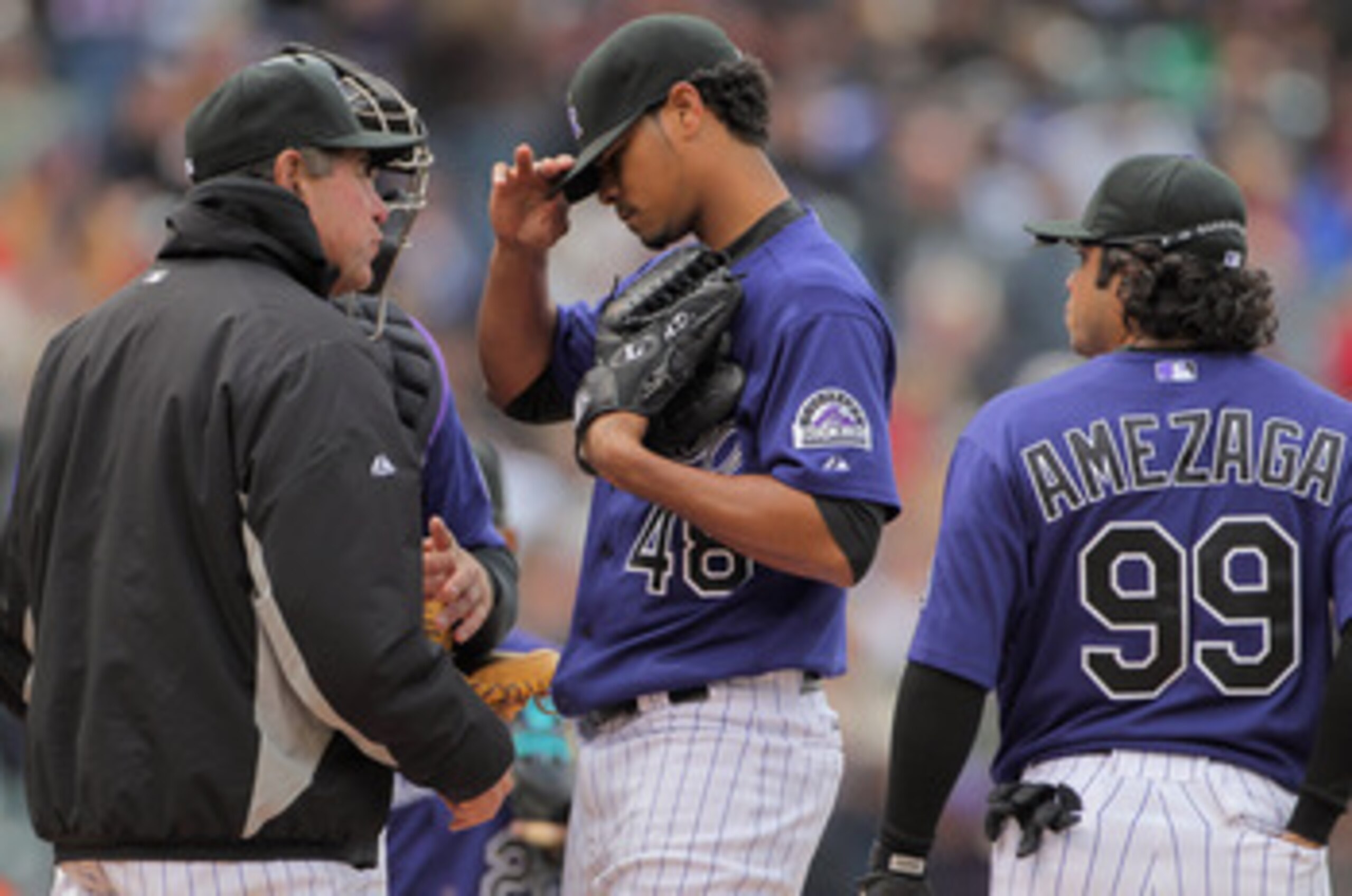 DENVER, CO - MAY 01:  Pitching coach Bob Apodaca (L) of the Colorado Rockies visits the mound to talk with pitcher Esmil Rogers #48 of the Colorado Rockies as he works against the Pittsburgh Pirates at Coors Field on May 1, 2011 in Denver, Colorado. The P