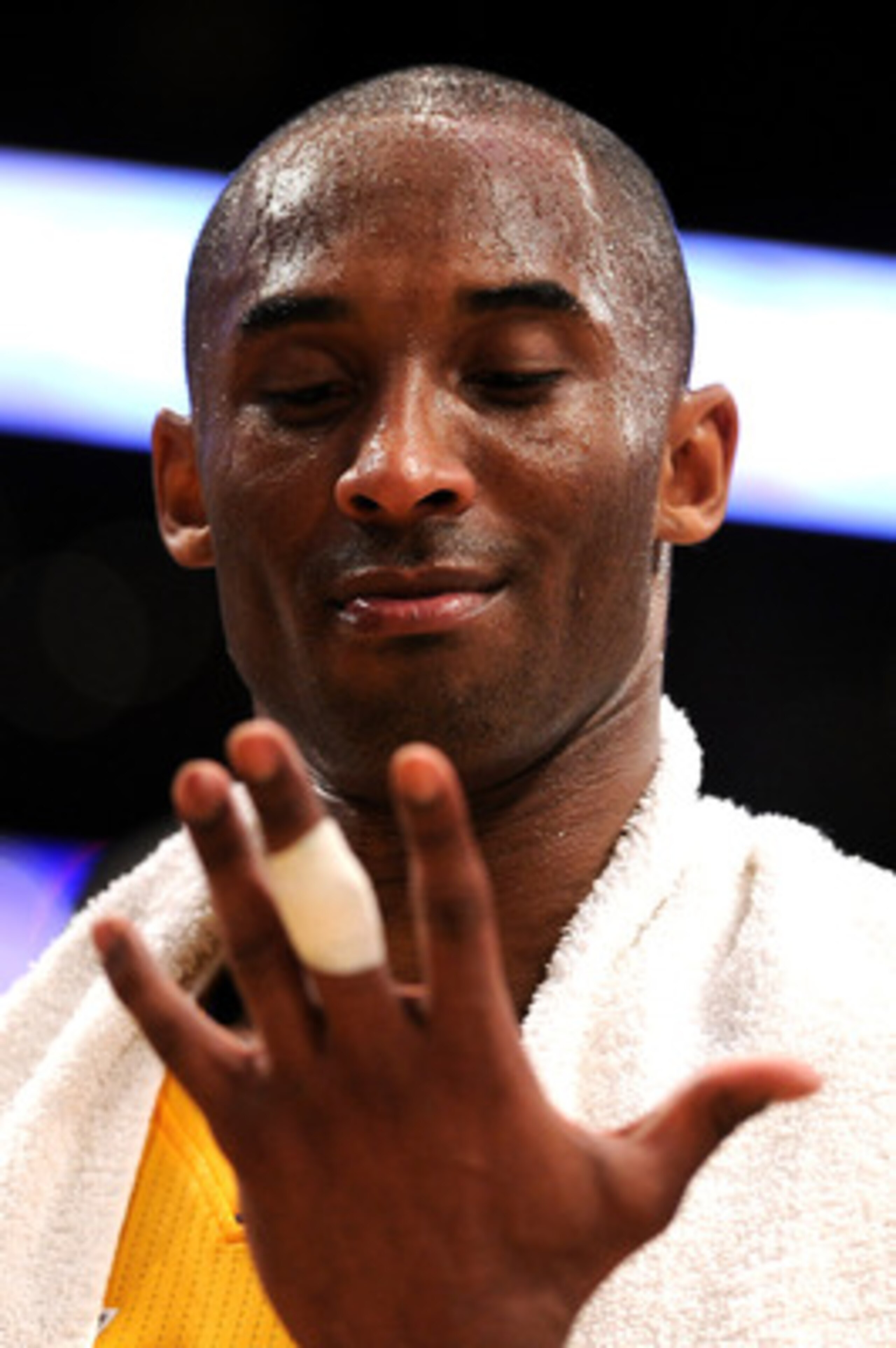 LOS ANGELES, CA - APRIL 26:  Kobe Bryant #24 of the Los Angeles Lakers looks at his hand from the bench in the third quarter while taking on the New Orleans Hornets in Game Five of the Western Conference Quarterfinals in the 2011 NBA Playoffs on April 26,