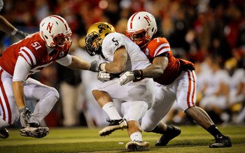 LINCOLN, NE - NOVEMBER 26: DeJon Gomes #7 and Will Compton #51 of the Nebraska Cornhuskers crunch Rodney Stewart #5 of the Colorado Buffaloes during the second half of their game at Memorial Stadium on November 26, 2010 in Lincoln, Nebraska. Nebraska defe