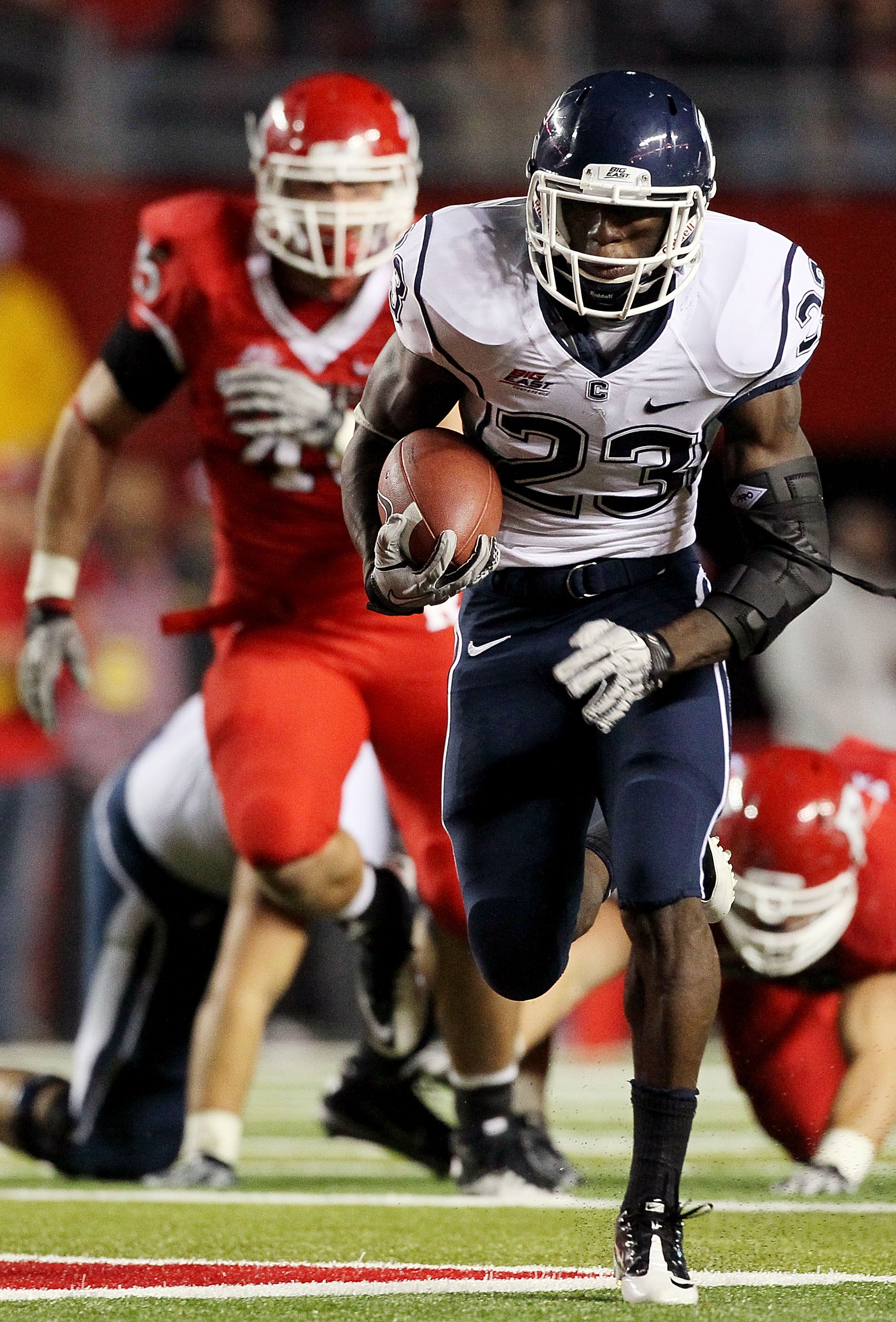PISCATAWAY, NJ - OCTOBER 08:  Jordan Todman #23 of the Connecticut Huskies runs for a second-quarter touchdown against the Rutgers Scarlet Knights at Rutgers Stadium on October 8, 2010 in Piscataway, New Jersey.  (Photo by Jim McIsaac/Getty Images)