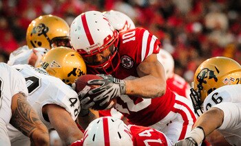 LINCOLN, NE - NOVEMBER 26: Roy Helu Jr. #10 of the Nebraska Cornhuskers dives for the endzone through the Colorado Buffaloes during their game at Memorial Stadium on November 26, 2010 in Lincoln, Nebraska. Nebraska defeated Colorado 45-17 (Photo by Eric F