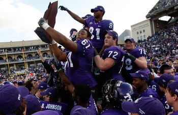 FORT WORTH, TX - NOVEMBER 28:  Marcus Cannon #61, Kyle Dooley #72 and Alonzo Adams #81 of the TCU Horned Frogs raise the Mountain West Regular Season Championship trophy at Amon G. Carter Stadium on November 28, 2009 in Fort Worth, Texas.  (Photo by Ronal