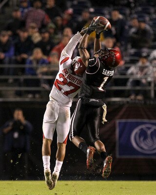 SAN DIEGO - NOVEMBER 20:  Wide receiver DeMarco Sampson #1 of the San Diego State Aztecs makes a catch over cornerback Brandon Burton #27 of the Utah Utes at Qualcomm Stadium on November 20, 2010 in San Diego, California.  Utah won 38-34.  (Photo by Steph