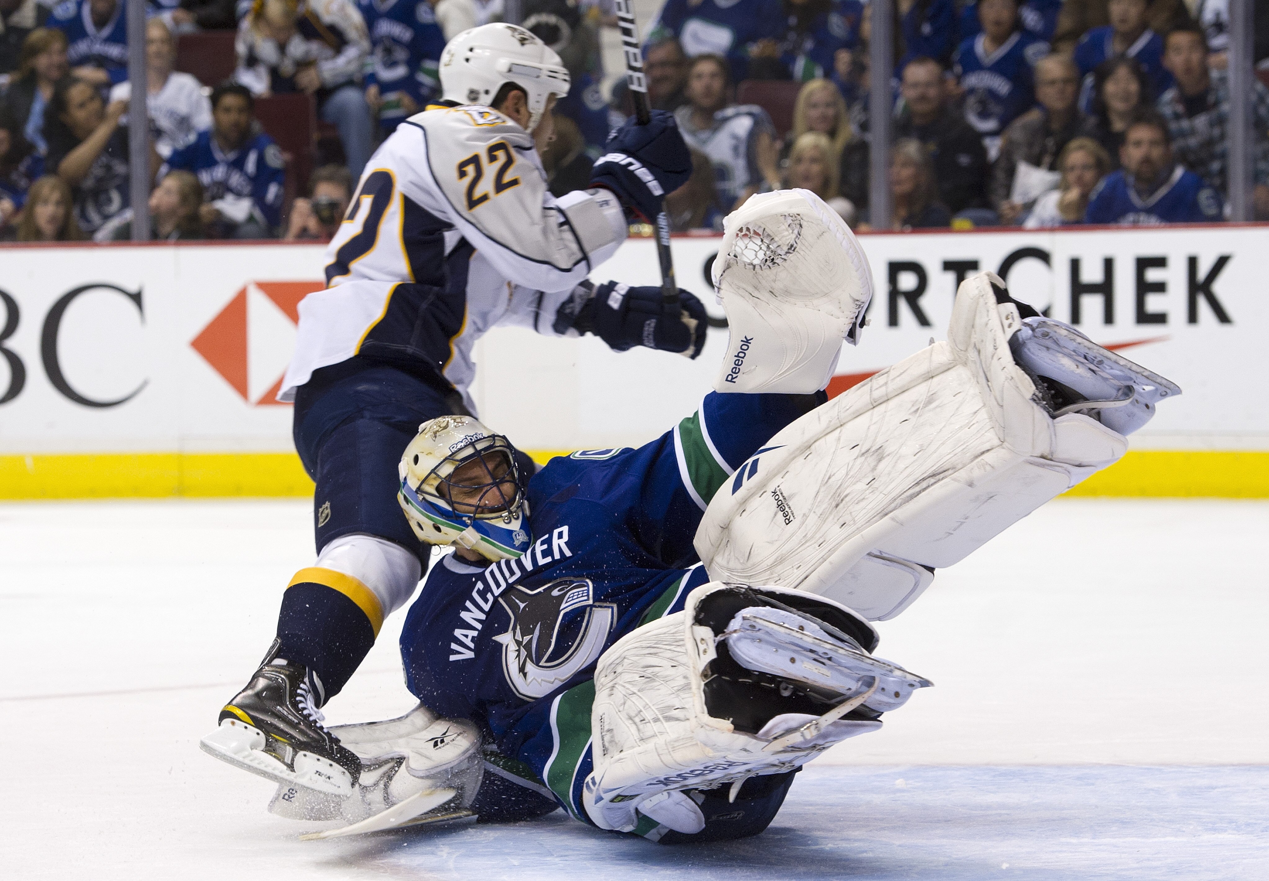 VANCOUVER, CANADA - APRIL 30: Jordin Tootoo #22 of the Nashville Predators clips goalie Roberto Luongo #1 of the Vancouver Canucks after getting stopped on a breakaway during the third period in Game Two of the Western Conference Semifinals during the 201