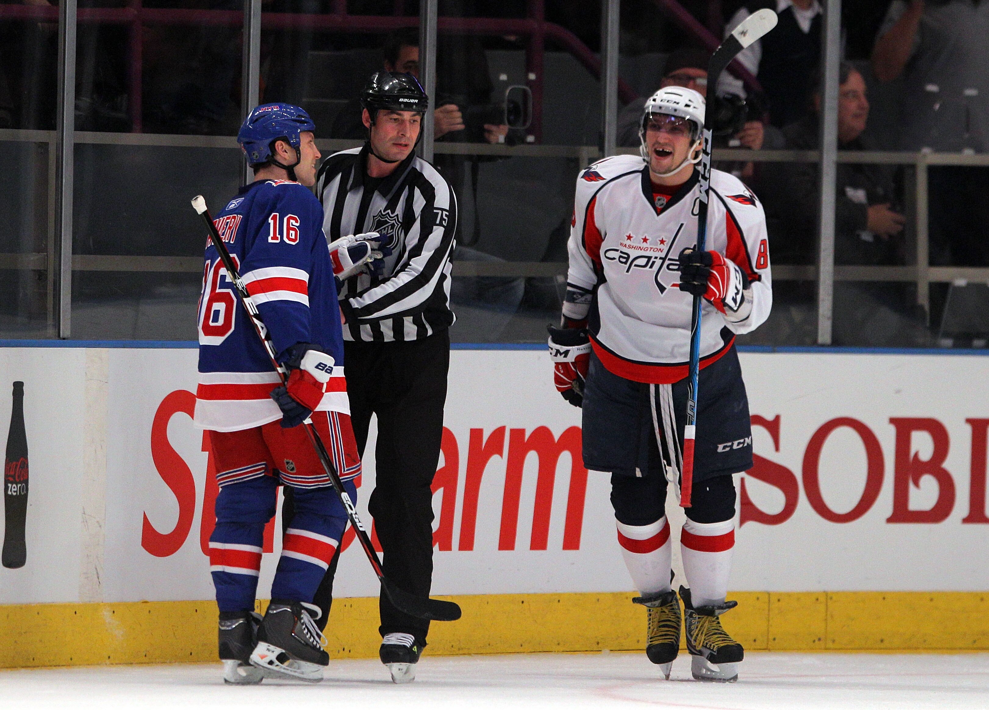 NEW YORK, NY - APRIL 20:  Linesman Derek Amell #75 (C) gets between Sean Avery #16 of the New York Rangers and Alex Ovechkin #8 (R) of the Washington Capitals in Game Four of the Eastern Conference Quarterfinals during the 2011 NHL Stanley Cup Playoffs at