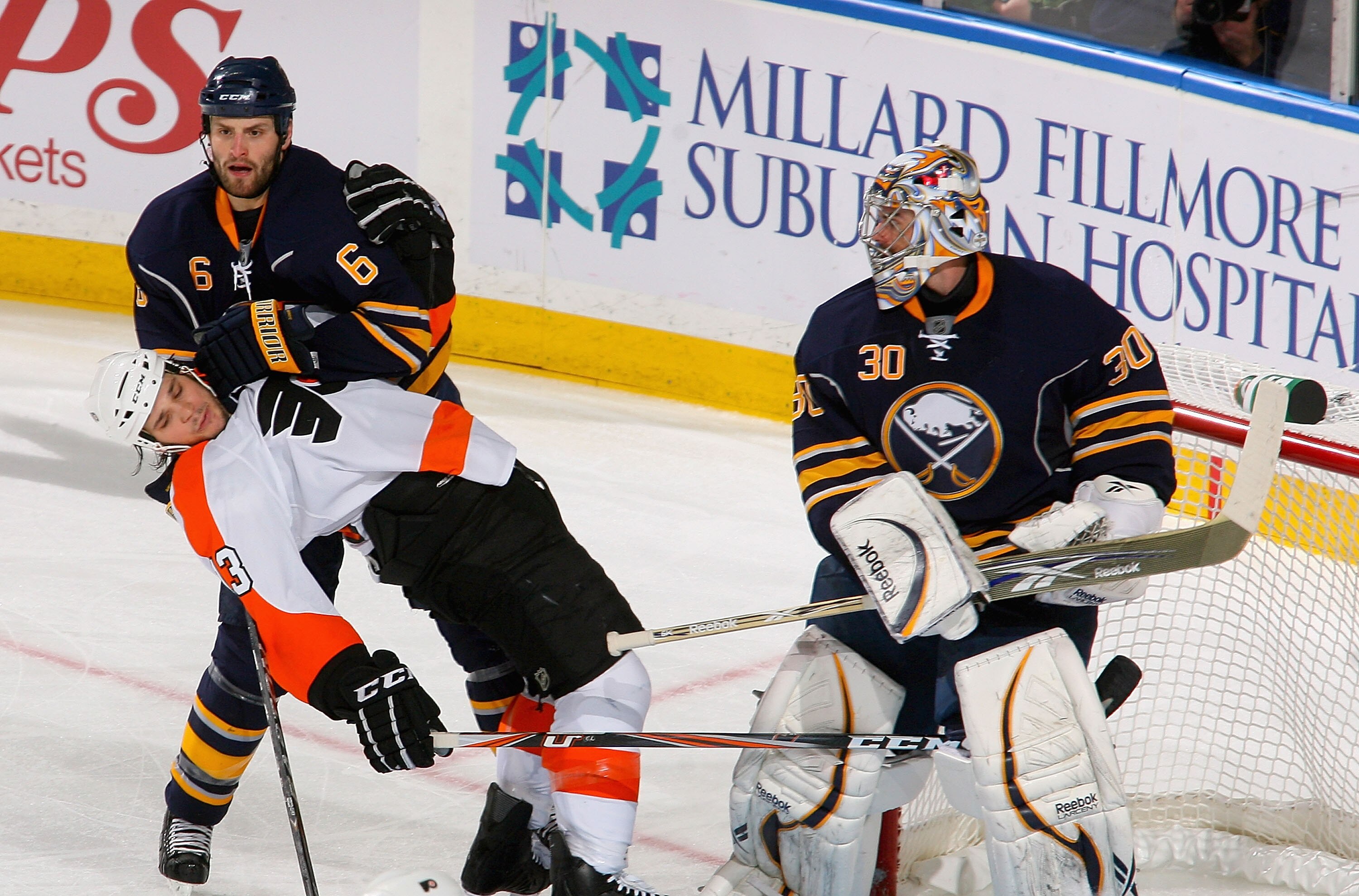 BUFFALO, NY - APRIL 20: Daniel Carcillo #13 of the Philadelphia Flyers is pushed down by Mike Weber #6 of the Buffalo Sabres after being hit by Ryan Miller #30 in Game Four of the Eastern Conference Quarterfinals during the 2011 NHL Stanley Cup Playoffs a