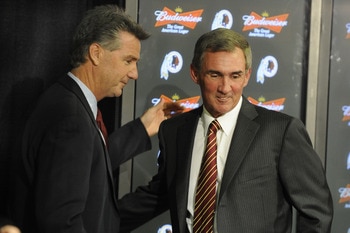 ASHBURN,VA - JANUARY 6:  Mike Shanahan, the new Executive Vice President and head coach of the Washington Redskins and Bruce Allen Executive Vice President shake hands before a press conference welcoming Shanahan to the Redskins on January 6, 2010 at Reds
