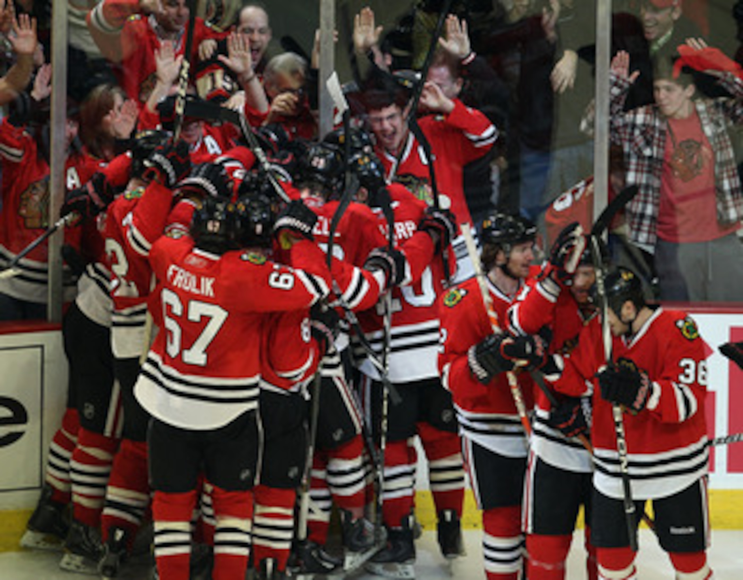 CHICAGO, IL - APRIL 24: Members of the Chicago Blackhawks celebrate an overtime win against the Vancouver Canucks in Game Six of the Western Conference Quarterfinals during the 2011 NHL Stanley Cup Playoffs at the United Center on April 24, 2011 in Chicag