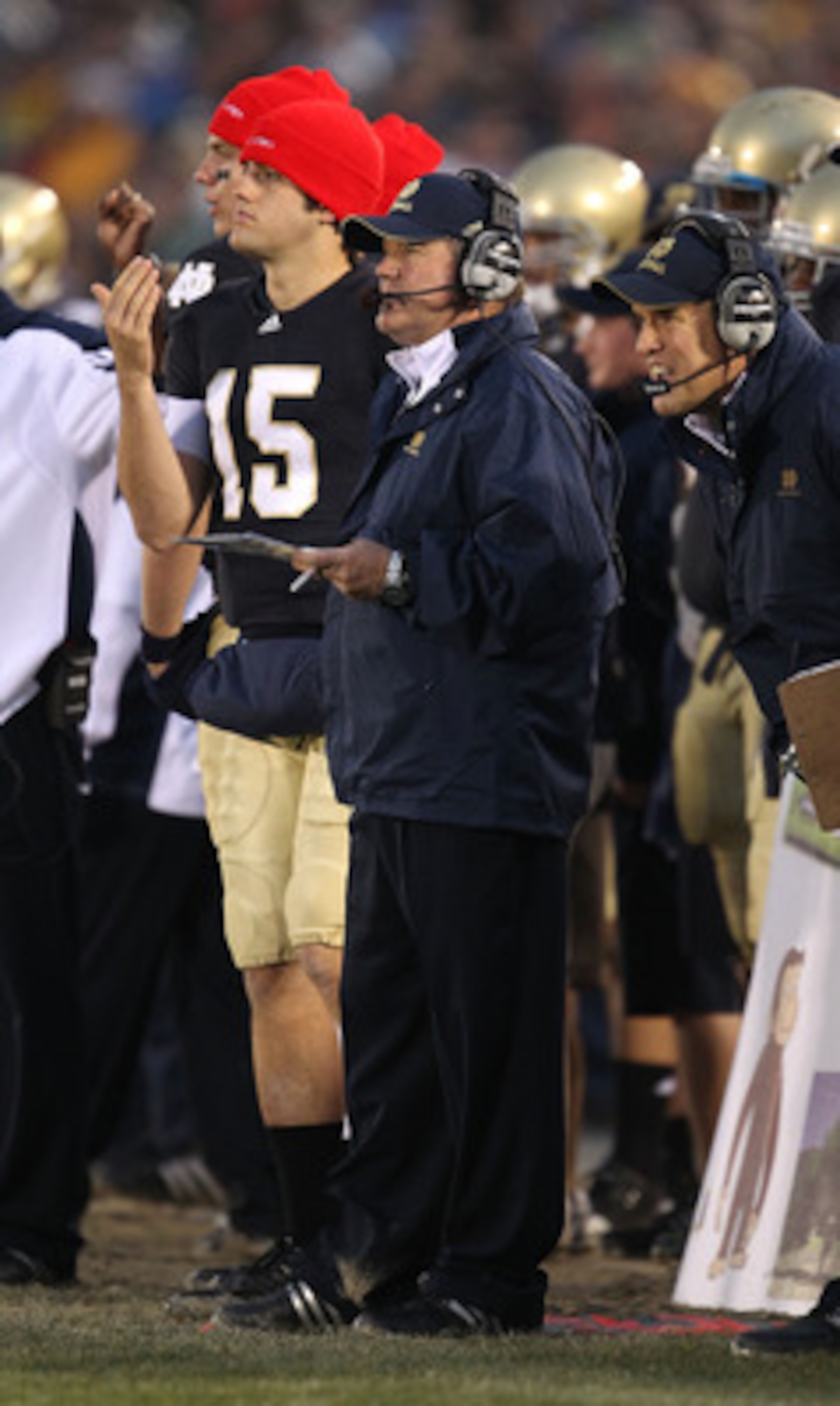 SOUTH BEND, IN - NOVEMBER 13: Head coach Brian Kelly of the Notre Dame Fighting Irish watches as his team takes on the Utah Utes while Brian Castello #15 signals a play at Notre Dame Stadium on November 13, 2010 in South Bend, Indiana. Notre Dame defeated
