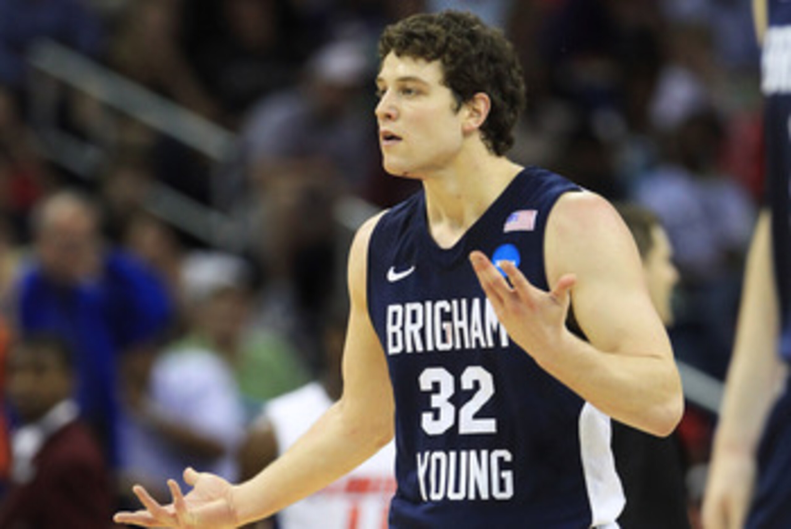 NEW ORLEANS, LA - MARCH 24:  Jimmer Fredette #32 of the Brigham Young Cougars reacts after being injured during their game against the Florida Gators in the Southeast regional of the 2011 NCAA men's basketball tournament at New Orleans Arena on March 24, 