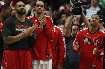 CHICAGO, IL - APRIL 26: (L-R) Carlos Boozer #5, Joakim Noah #13 and Derrick Rose #1 of the Chicago Bulls celebrate a win over the Indiana Pacers in Game Five of the Eastern Conference Quarterfinals in the 2011 NBA Playoffs at the United Center on April 26
