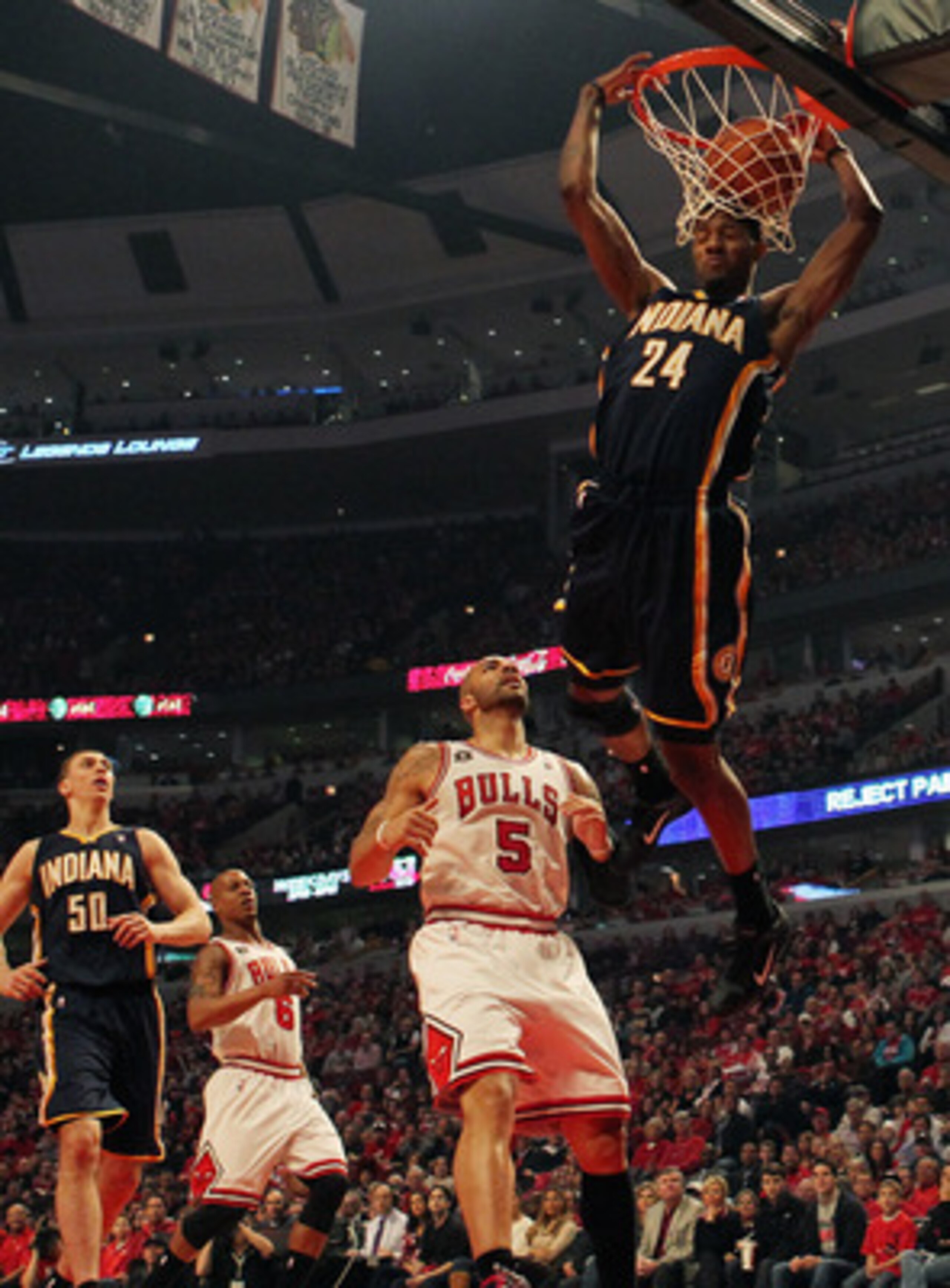 CHICAGO, IL - APRIL 16: Paul George #24 of the Indiana Pacers dunks the ball over Carlos Boozer #5 of the Chicago Bulls in Game One of the Eastern Conference Quarterfinals in the 2011 NBA Playoffs at the United Center on April 16, 2011 in Chicago, Illinoi CHICAGO, IL - APRIL 16: Paul George #24 of the Indiana Pacers dunks the ball over Carlos Boozer #5 of the Chicago Bulls in Game One of the Eastern Conference Quarterfinals in the 2011 NBA Playoffs at the United Center on April 16, 2011 in Chicago, Illinoi
