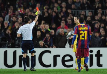 BARCELONA, SPAIN - MARCH 08:  Robin van Persie of Arsenal receives a red card from referee Massimo Busacca during the UEFA Champions League round of 16 second leg match between Barcelona and Arsenal at the Nou Camp Stadium on March 8, 2011 in Barcelona, S