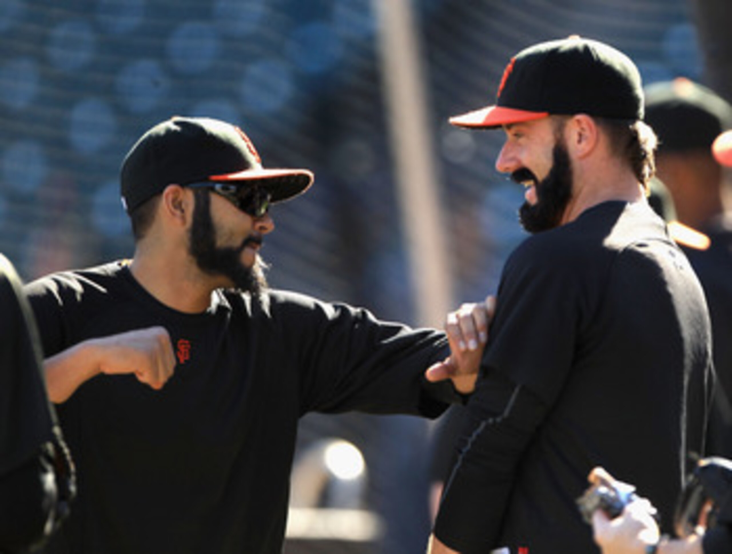 SAN FRANCISCO - OCTOBER 13:  Brian Wilson and Sergio Romo of the San Francisco Giants joke around during a workout session in preparation for the National League Championship Series at AT&T Park on October 13, 2010 in San Francisco, California.  (Photo by