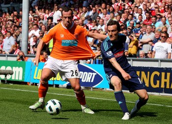 BLACKPOOL, ENGLAND - APRIL 30:  Dean Whitehead of Stoke City tangles with Charlie Adam of Blackpool during the Barclays Premier League match between Blackpool and Stoke City at Bloomfield Road on April 30, 2011 in Blackpool, England.  (Photo by Clive Brun