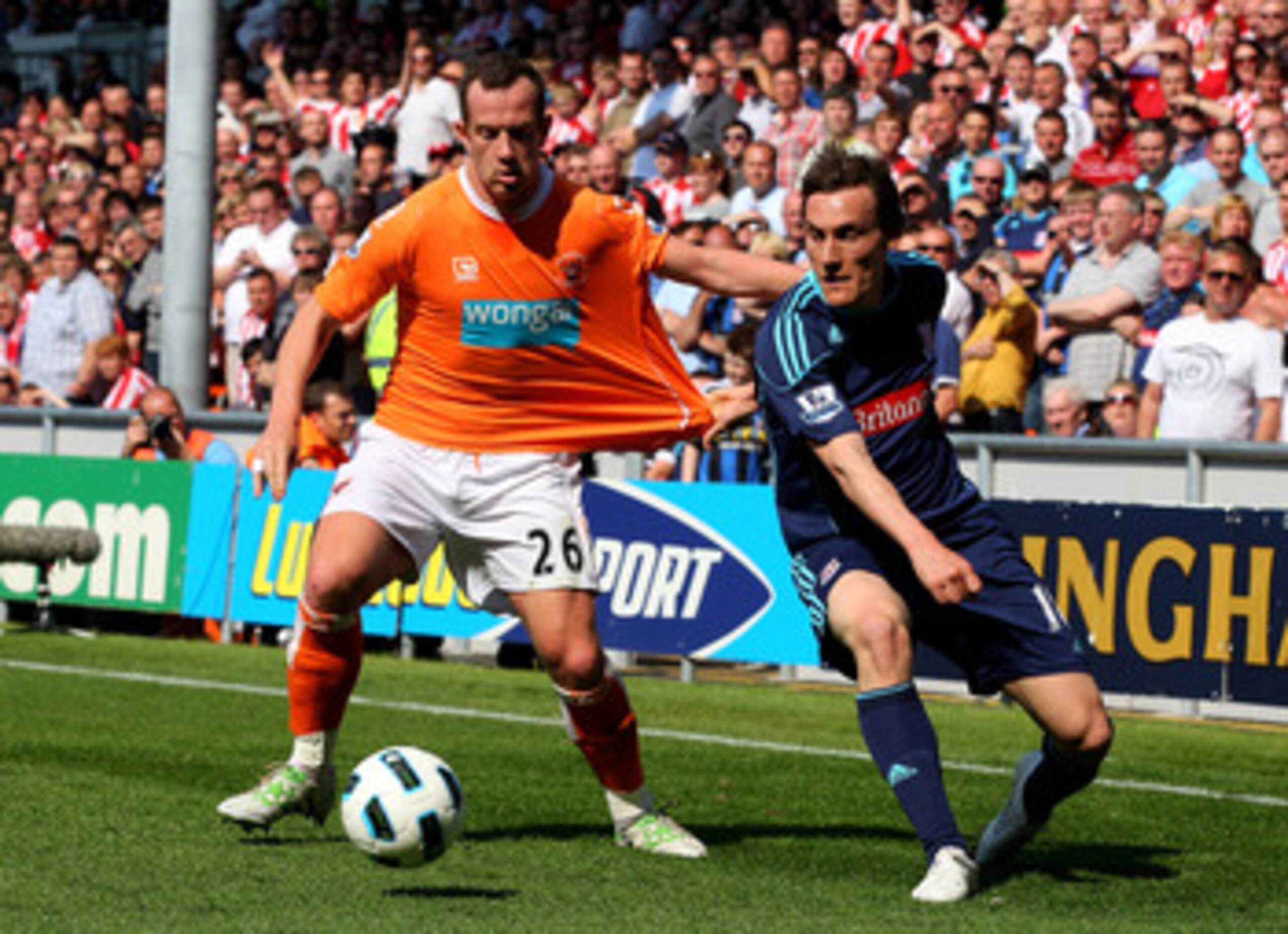 BLACKPOOL, ENGLAND - APRIL 30:  Dean Whitehead of Stoke City tangles with Charlie Adam of Blackpool during the Barclays Premier League match between Blackpool and Stoke City at Bloomfield Road on April 30, 2011 in Blackpool, England.  (Photo by Clive Brun