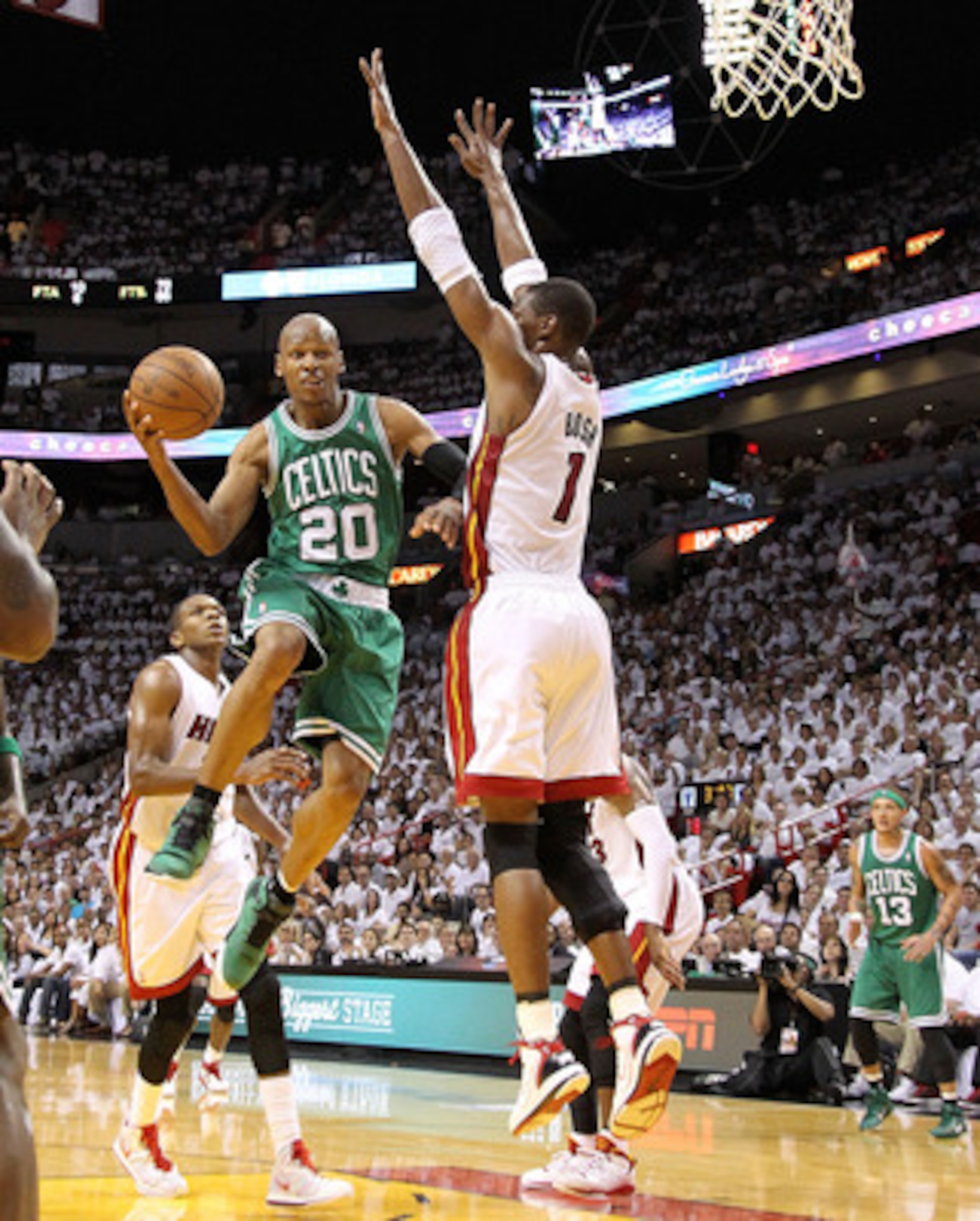 MIAMI, FL - MAY 01:  Ray Allen #20 of the Boston Celtics shoots over Chris Bosh #1 of the Miami Heat during game one of the Eastern Conference Semifinals of the 2011 NBA Playoffs at American Airlines Arena on May 1, 2011 in Miami, Florida. NOTE TO USER: U