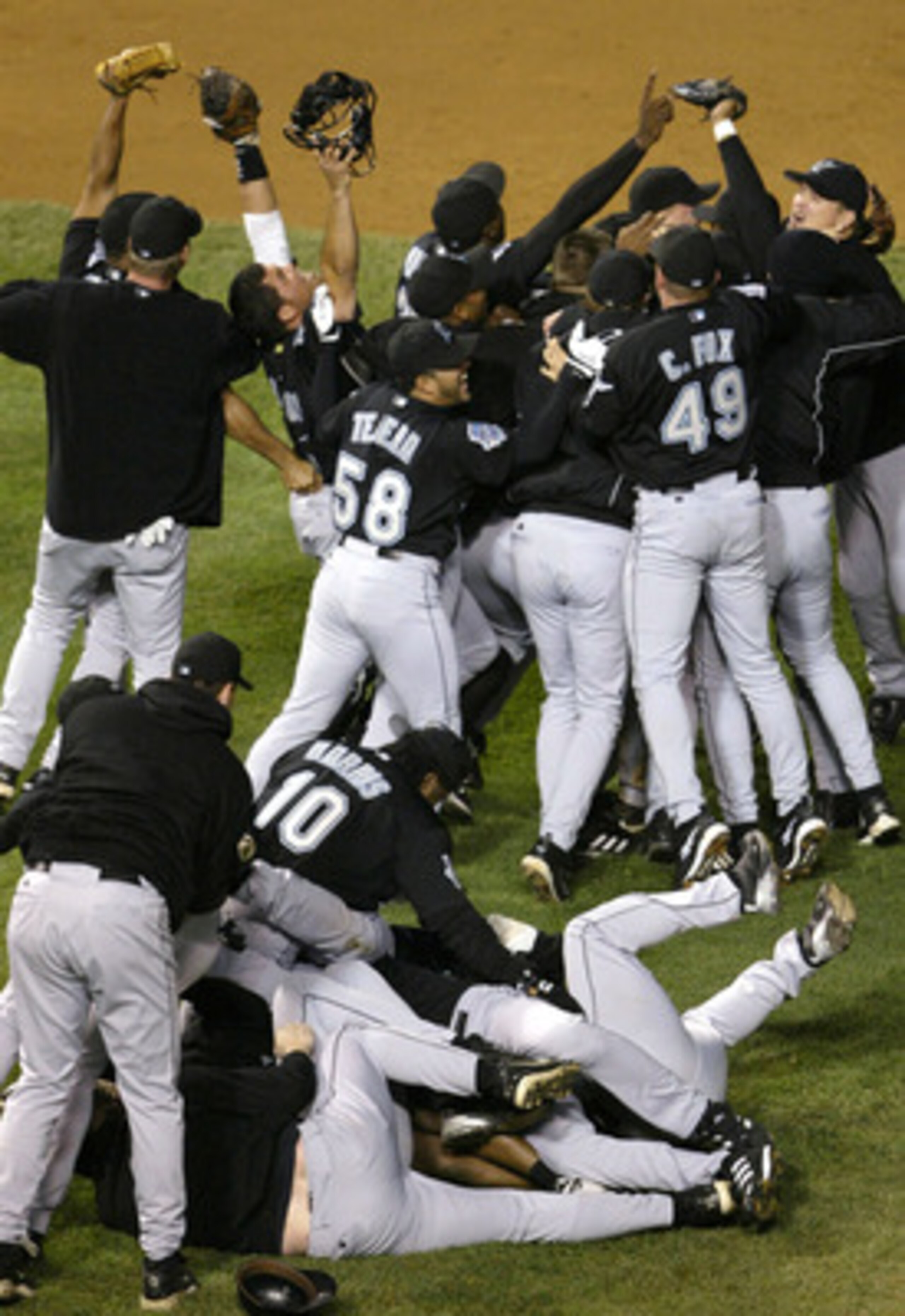CHICAGO - OCTOBER 15:  Members of the Florida Marlins celebrate their 9-6 win over the Chicago Cubs during game seven of the National League Championship Series October 15, 2003 at Wrigley Field in Chicago, Illinois. (Photo by Elsa/Getty Images)