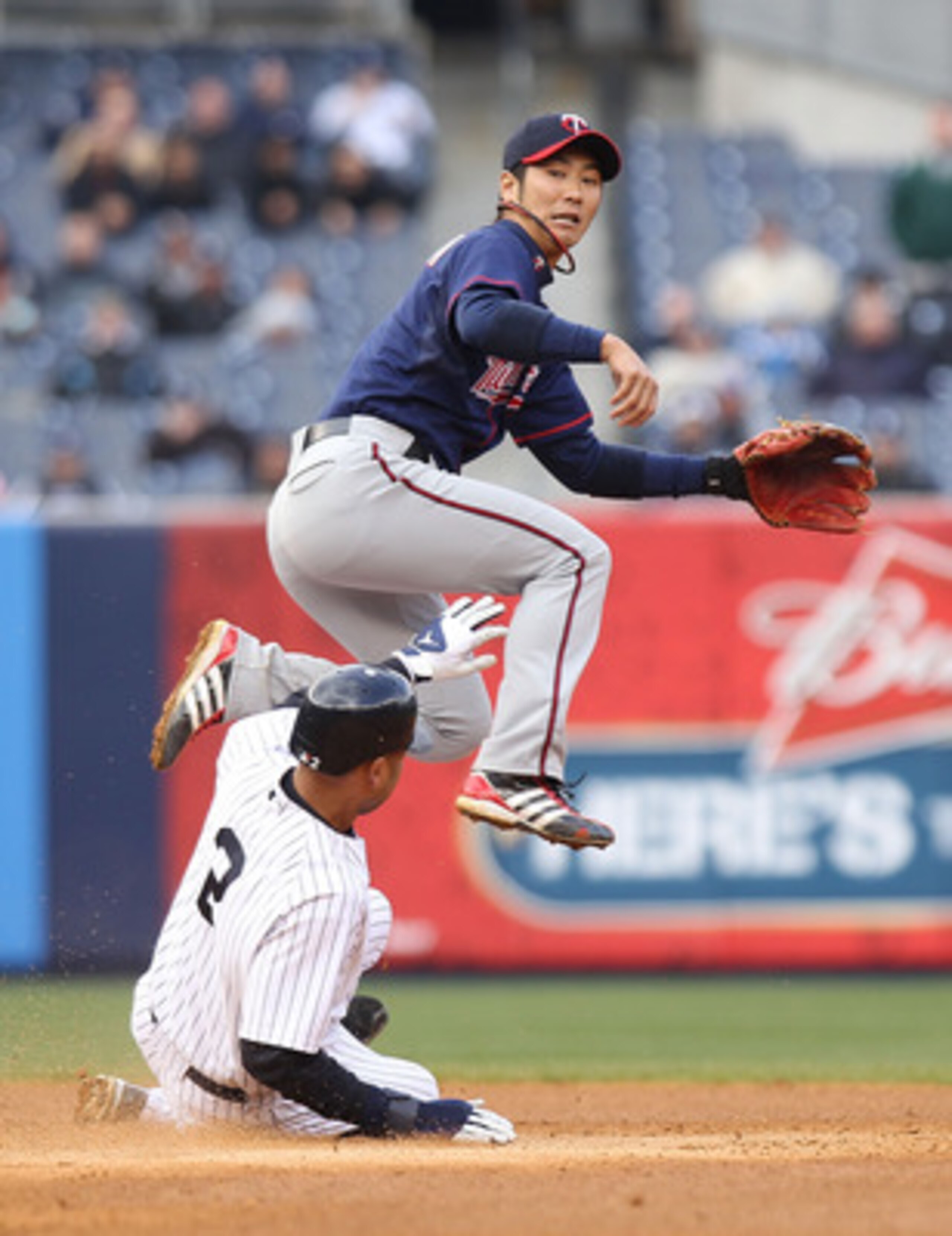NEW YORK, NY - APRIL 07:  Tsuyoshi Nishioka #1 of the Minnesota Twins fails to turn the double play over Derek Jeter #2 of the New York Yankees at Yankee Stadium on April 7, 2011 in the Bronx borough of New York City.  (Photo by Nick Laham/Getty Images)