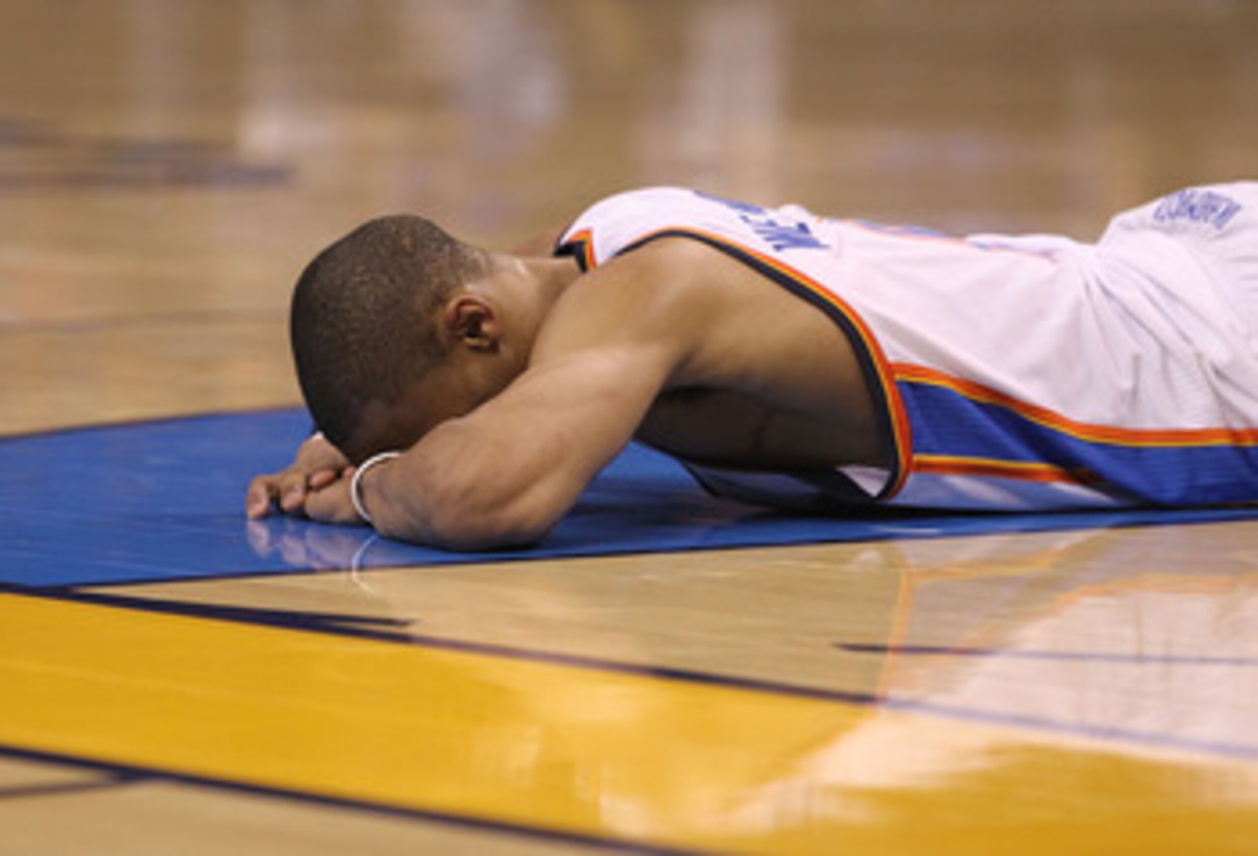 OKLAHOMA CITY, OK - MAY 01:  Guard Russell Westbrook #0 of the Oklahoma City Thunder falls on the court after a foul during a 114-101 loss against the Memphis Grizzlies in Game One of the Western Conference Semifinals in the 2011 NBA Playoffs on May 1, 20