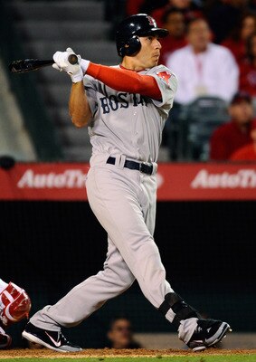 ANAHEIM, CA - APRIL 21:  Jacoby Ellsbury #2 of the Boston Red Sox hits a two run single against the Los Angeles Angels of Anaheim to score teammates David Ortiz #34 and Jed Lowrie # 12 during the sixth inning of the baseball game at Angel Stadium of Anahe