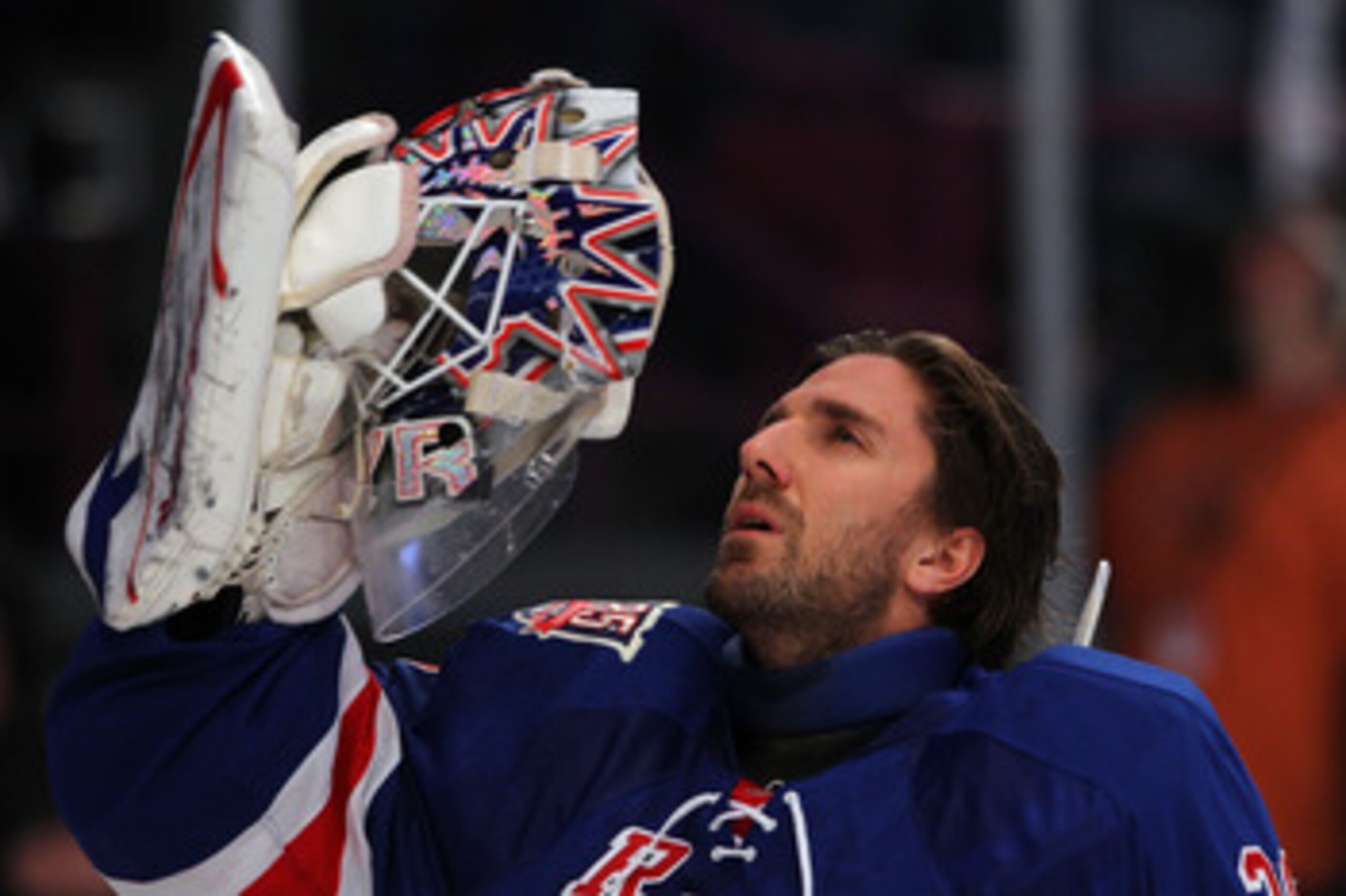 NEW YORK, NY - APRIL 20:  Goalie Henrik Lundqvist #30 of the New York Rangers adjusts his mask against the Washington Capitals in Game Four of the Eastern Conference Quarterfinals during the 2011 NHL Stanley Cup Playoffs at Madison Square Garden on April 