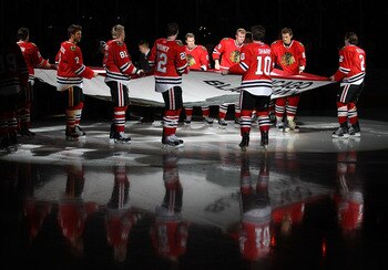 CHICAGO - OCTOBER 09: Members of the Chicago Blackhawks carry the Stanley Cup Championship banner across the ice in a ceremony before the Blackhawks season home opening game against the Detroit Red Wings at the United Center on October 9, 2010 in Chicago, CHICAGO - OCTOBER 09: Members of the Chicago Blackhawks carry the Stanley Cup Championship banner across the ice in a ceremony before the Blackhawks season home opening game against the Detroit Red Wings at the United Center on October 9, 2010 in Chicago,