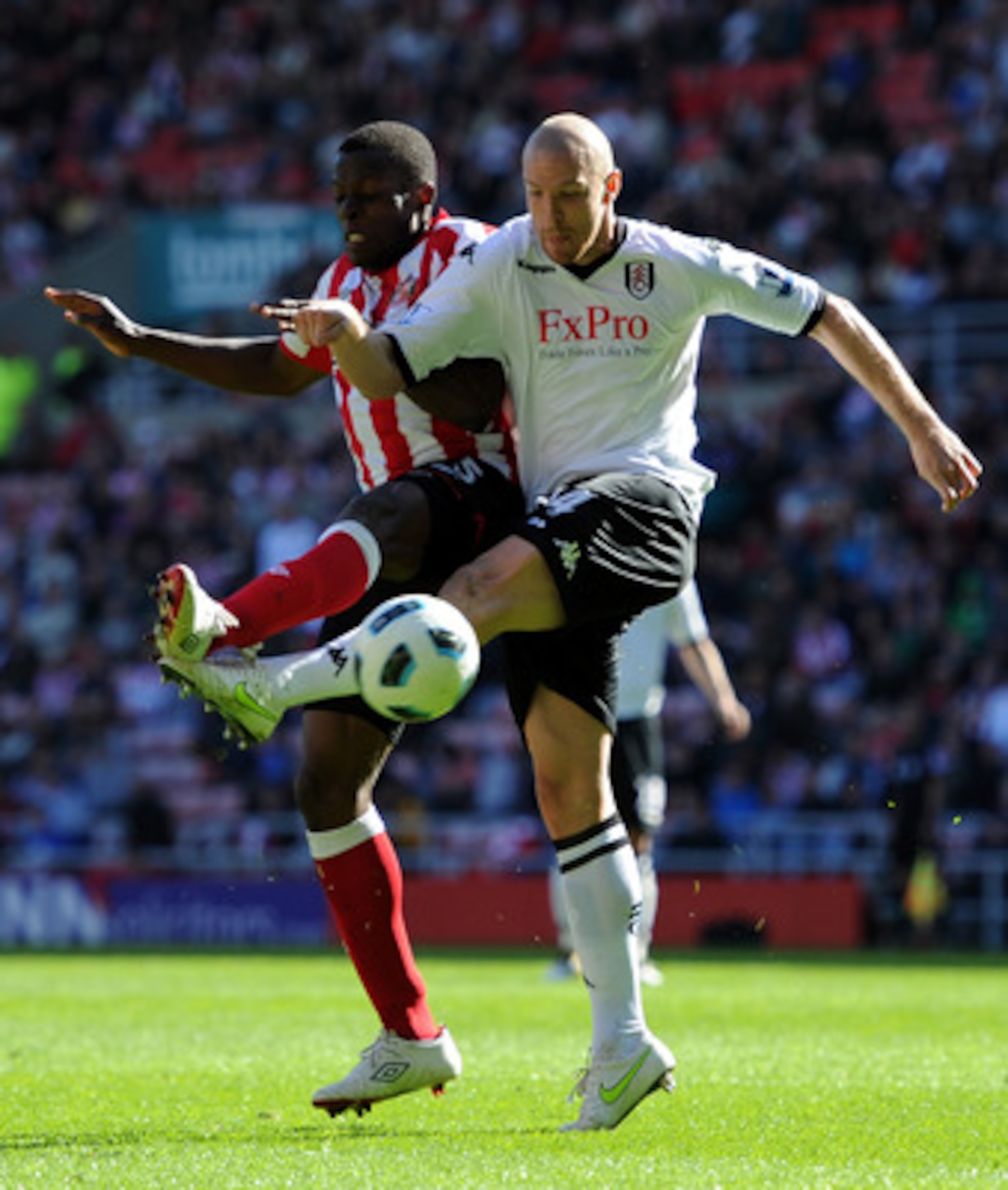 SUNDERLAND, ENGLAND - APRIL 30:  Nedum Onuoha(L) of Sunderland challenges Philippe Senderos of Fulham during the Barclays Premier League match between Sunderland and Fulham at Stadium of Light on April 30, 2011 in Sunderland, England.  (Photo by Chris Bru