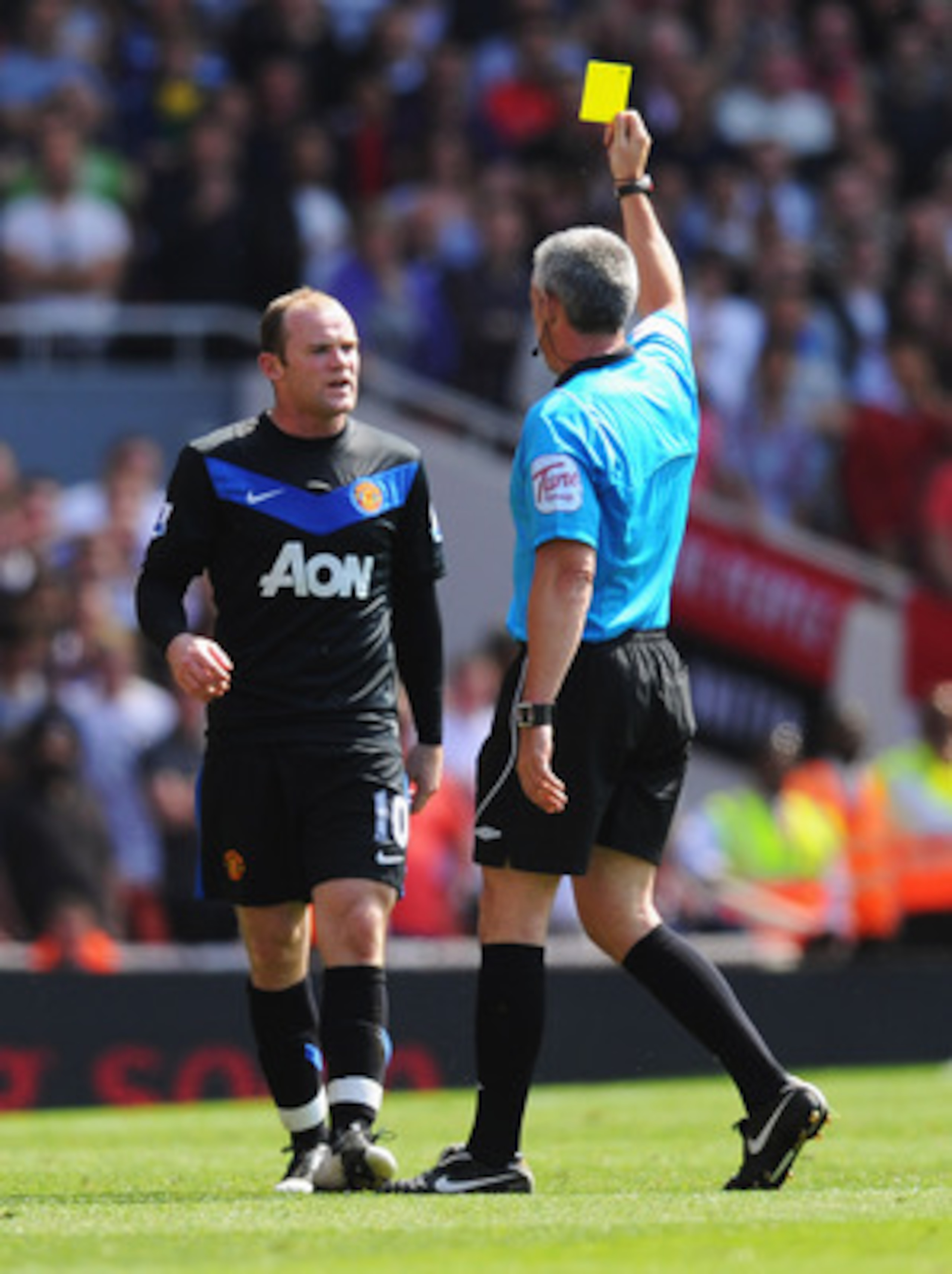 LONDON, ENGLAND - MAY 01:  Referee Chris Foy shows a yellow card to Wayne Rooney of Manchester United as he is booked during the Barclays Premier League match between Arsenal and Manchester United at the Emirates Stadium on May 1, 2011 in London, England.