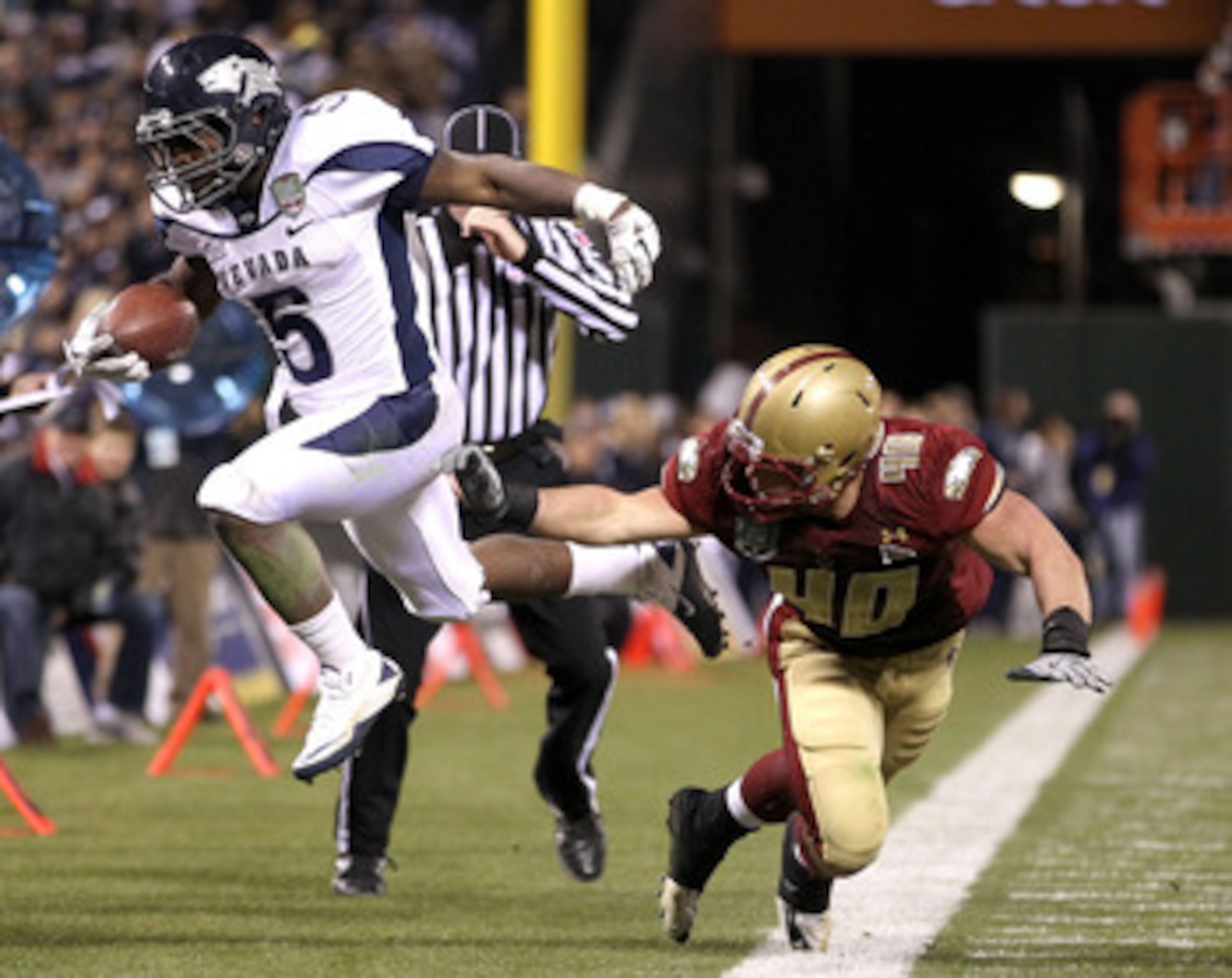 SAN FRANCISCO, CA - JANUARY 09:  Mike Ball #5 of the Nevada Wolf Pack is pushed out of bounds by Luke Kuechly #40 of Boston College during the Kraft Fight Hunger Bowl at AT&T Park on January 9, 2011 in San Francisco, California.  (Photo by Ezra Shaw/Getty