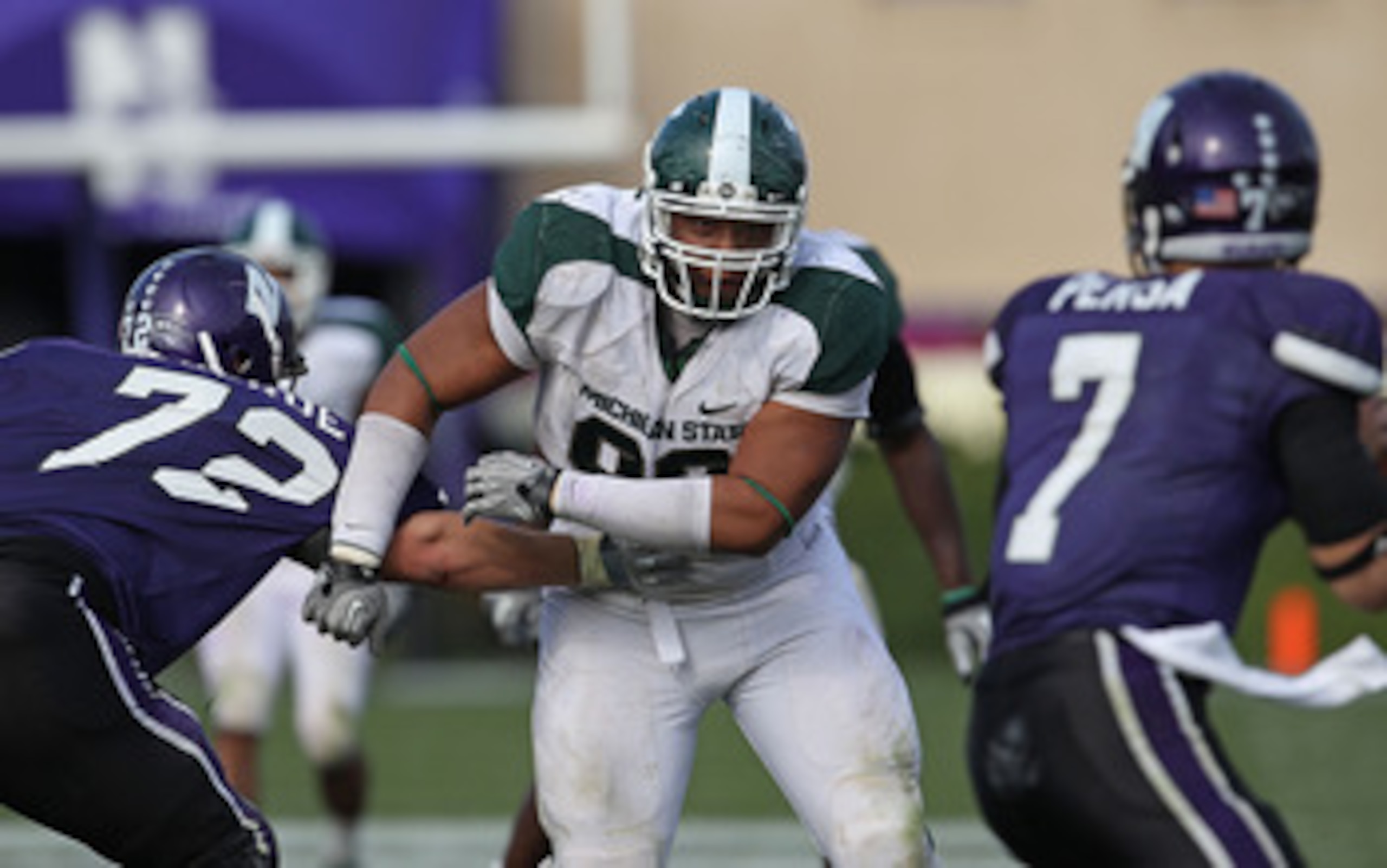 EVANSTON, IL - OCTOBER 23: Jerel Worthy #99 of the Michigan State Spartans moves past a block attempt by Brian Mulroe #72 of the Northwestern Wildcats with his sights set on Dan Persa #7 at Ryan Field on October 23, 2010 in Evanston, Illinois. Michigan St