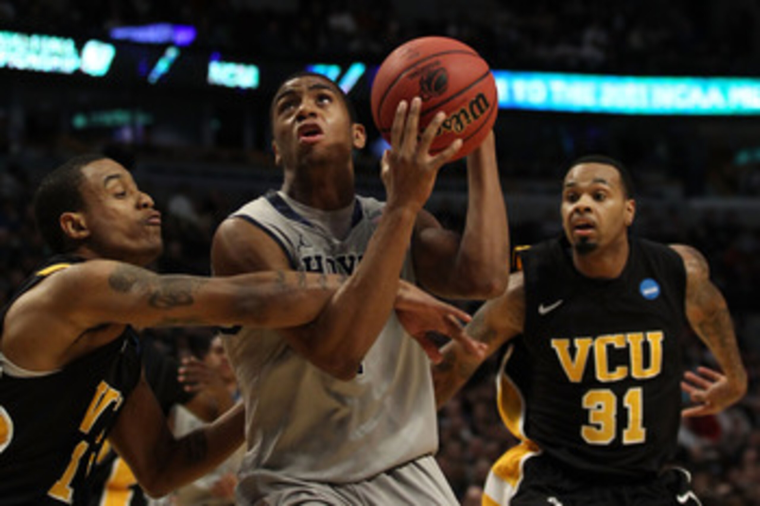 CHICAGO, IL - MARCH 18:  Hollis Thompson #1 of the Georgetown Hoyas looks to shoot against Darius Theus #10 and Toby Veal #31 of the Virginia Commonwealth Rams in the first half during the second round of the 2011 NCAA men's basketball tournament at the U