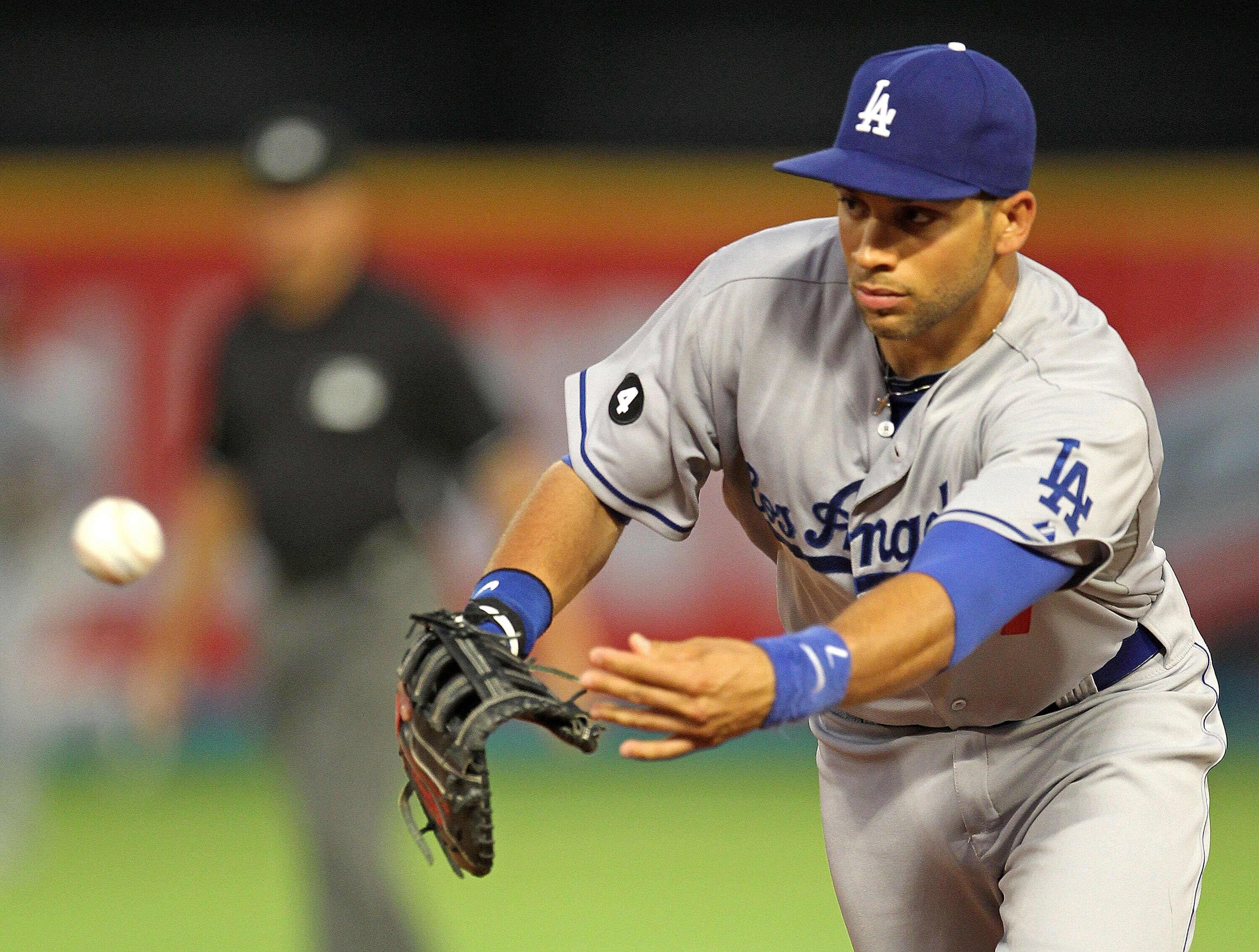MIAMI GARDENS, FL - APRIL 26:  James Loney #7 of the Los Angeles Dodgers tosses the ball to first during a game against the Florida Marlins at Sun Life Stadium on April 26, 2011 in Miami Gardens, Florida.  (Photo by Mike Ehrmann/Getty Images)