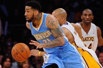 LOS ANGELES, CA - APRIL 03: Wilson Chandler #21 of the Denver Nuggets  drives past Derek Fisher #2 of the Los Angeles Lakers during the game at Staples Center on April 3, 2011 in Los Angeles, California. NOTE TO USER: User expressly acknowledges and agree