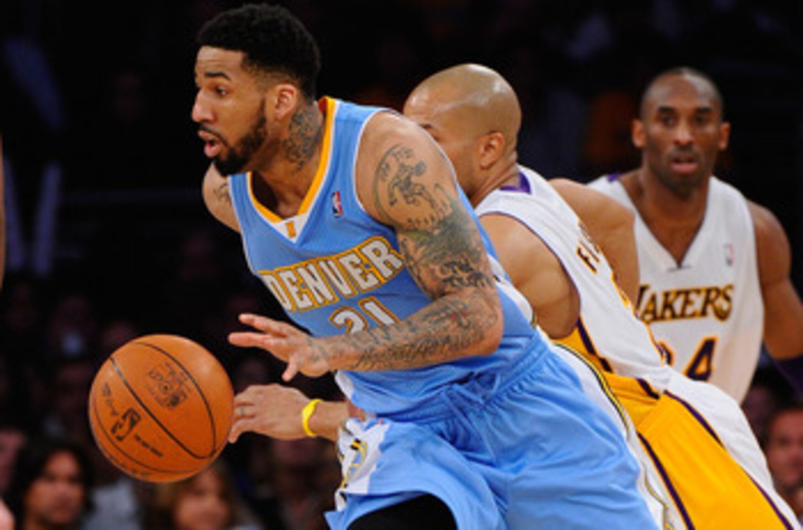 LOS ANGELES, CA - APRIL 03: Wilson Chandler #21 of the Denver Nuggets  drives past Derek Fisher #2 of the Los Angeles Lakers during the game at Staples Center on April 3, 2011 in Los Angeles, California. NOTE TO USER: User expressly acknowledges and agree