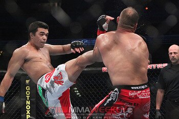 Randy Couture eating a vicious crane kick from Lyoto Machida