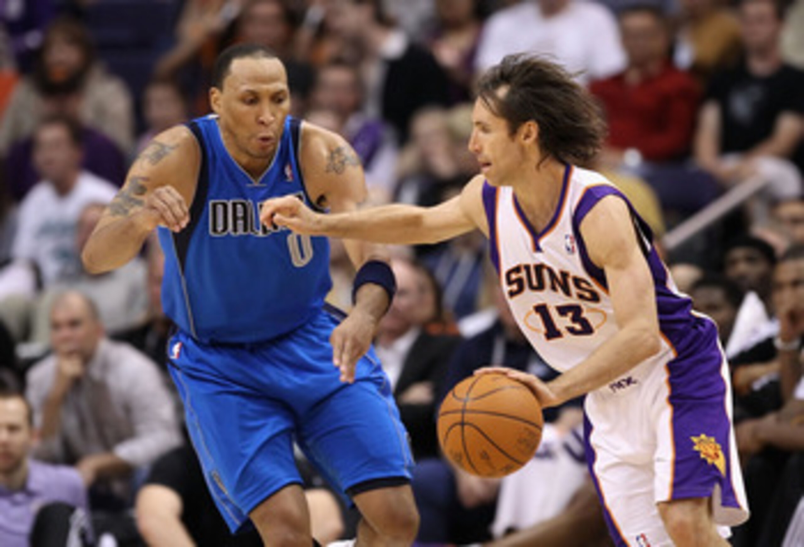 PHOENIX, AZ - MARCH 27:  Steve Nash #13 of the Phoenix Suns drives the ball past Shawn Marion #0 of the Dallas Mavericks during the NBA game at US Airways Center on March 27, 2011 in Phoenix, Arizona.  NOTE TO USER: User expressly acknowledges and agrees
