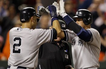 BALTIMORE, MD - APRIL 23:  Derek Jeter #2 congratulates Alex Rodriguez #13 of the New York Yankees after Rodriguez hit a grand slam home run against the Baltimore Orioles during the eighth inning at Oriole Park at Camden Yards on April 23, 2011 in Baltimo