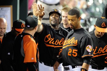 BALTIMORE, MD - APRIL 20:  Vladimir Guerrero #27 of the Baltimore Orioles celebrates with teammates after hitting a home run in the third inning against the Minnesota Twins at Oriole Park at Camden Yards on April 20, 2011 in Baltimore, Maryland.  (Photo b