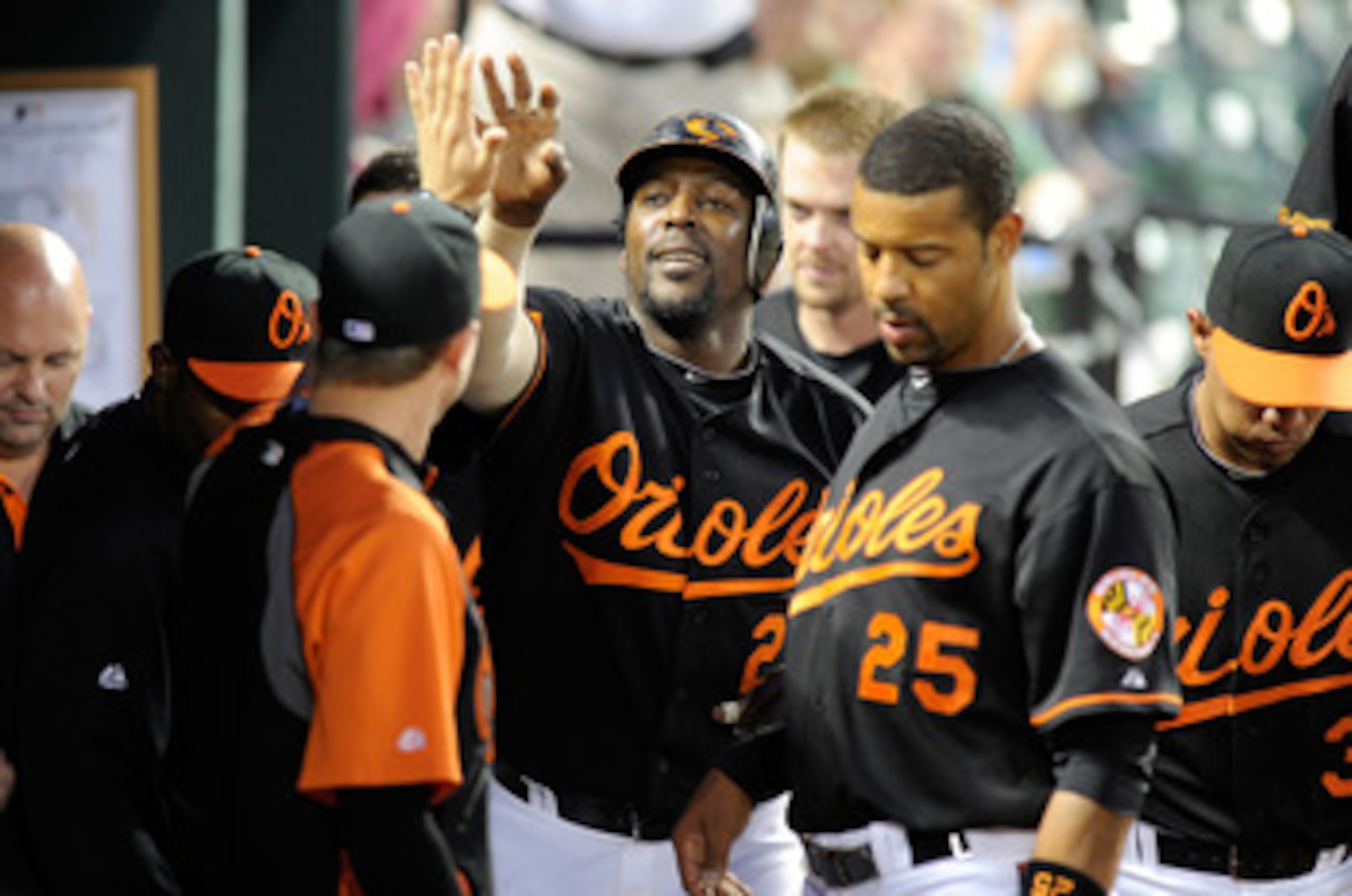 BALTIMORE, MD - APRIL 20:  Vladimir Guerrero #27 of the Baltimore Orioles celebrates with teammates after hitting a home run in the third inning against the Minnesota Twins at Oriole Park at Camden Yards on April 20, 2011 in Baltimore, Maryland.  (Photo b